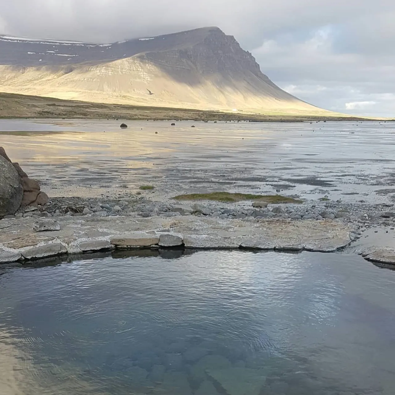 Krosslaug pool area with open Breiðafjörður coastal scenery.