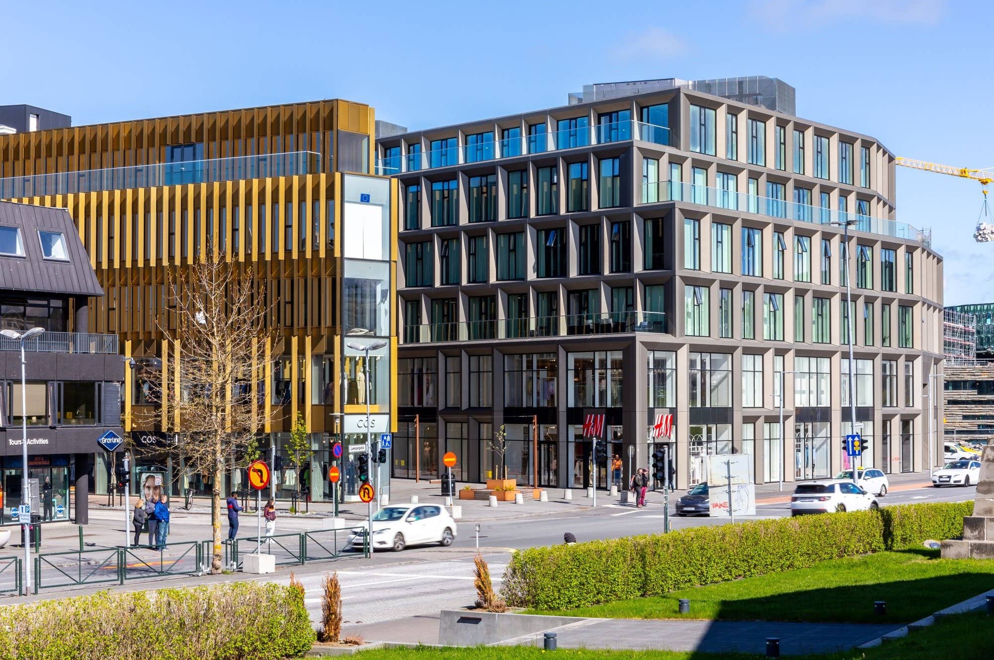 Modern buildings and traffic beside Lækjargata near Lækjartorg in Reykjavík.
