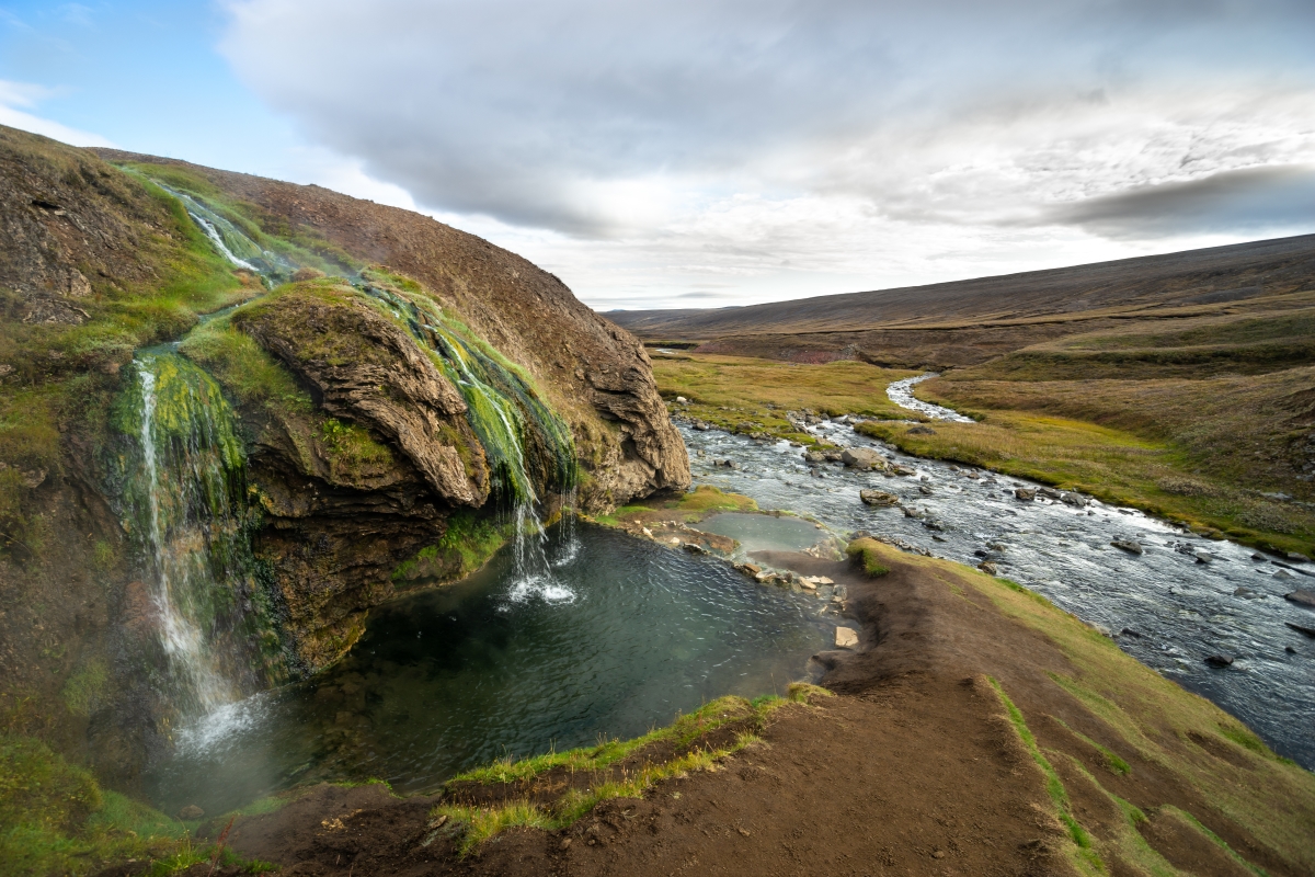 Laugavallalaug hot spring set in a remote East Iceland highland valley.