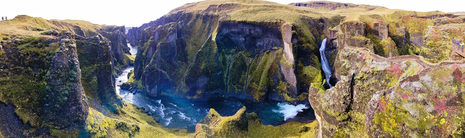 Wide view of Mögáfoss waterfall dropping into Fjaðrárgljúfur canyon.