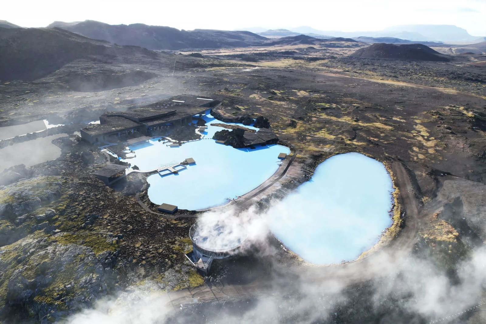 Aerial view of the rebuilt Earth Lagoon Mývatn pools among dark lava and volcanic ridges.
