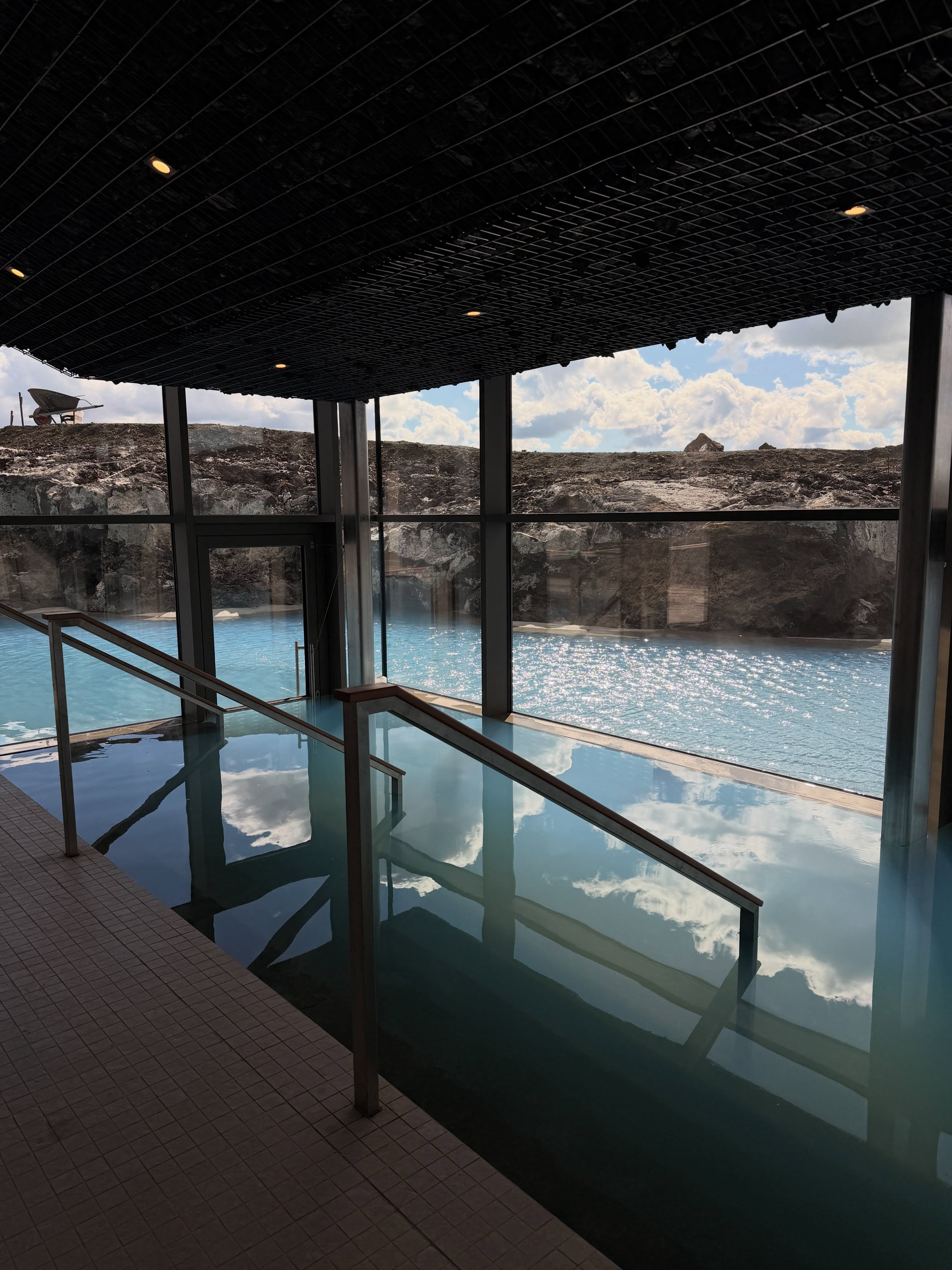 Steps descending through the new Earth Lagoon Mývatn building toward the outdoor geothermal lagoon.