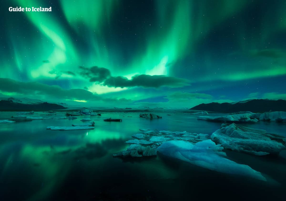 Green northern lights above floating ice at Jökulsárlón Glacier Lagoon.