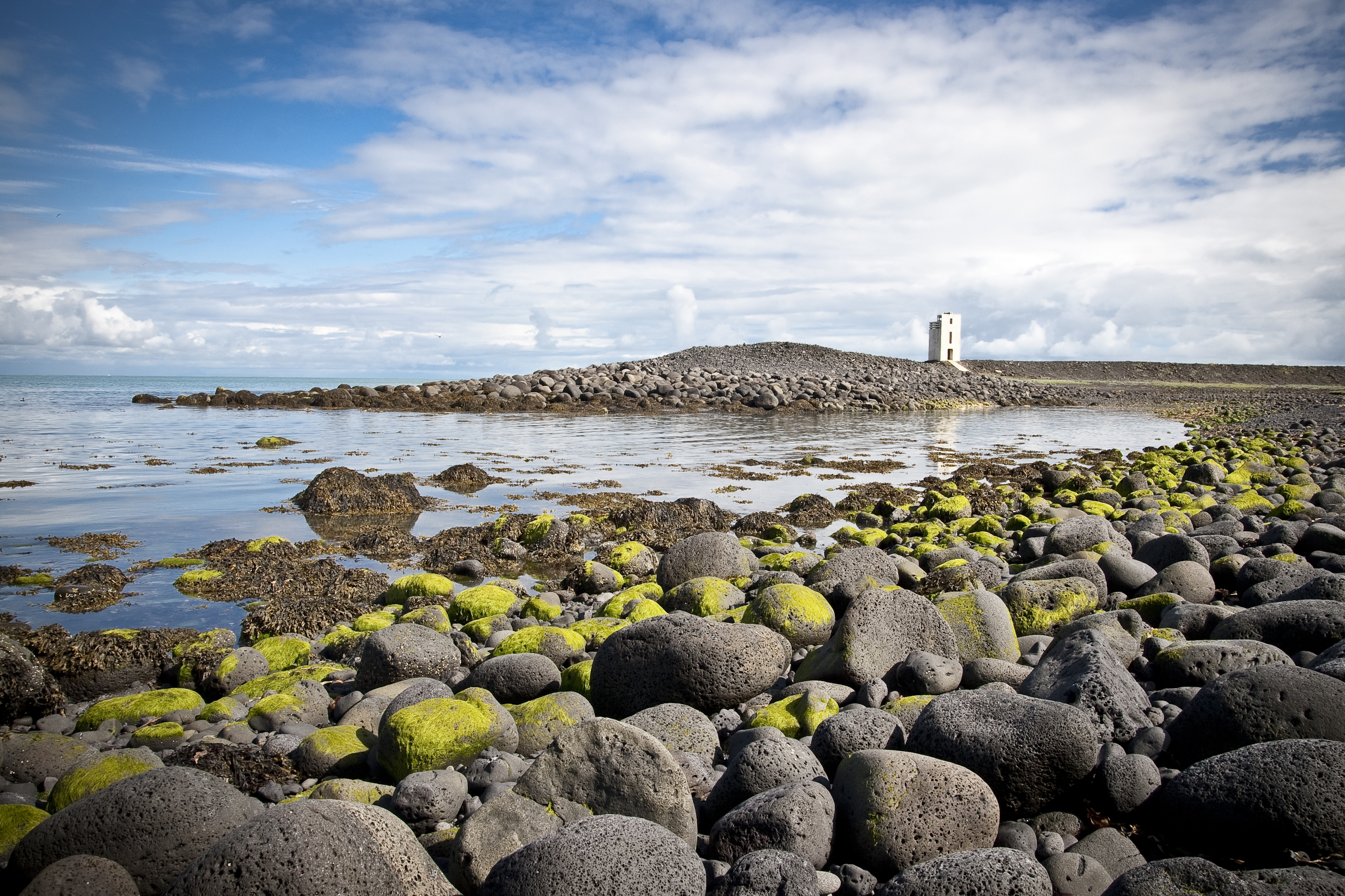 Rocky shoreline and Hafnarnesviti lighthouse on the coast south of Þorlákshöfn