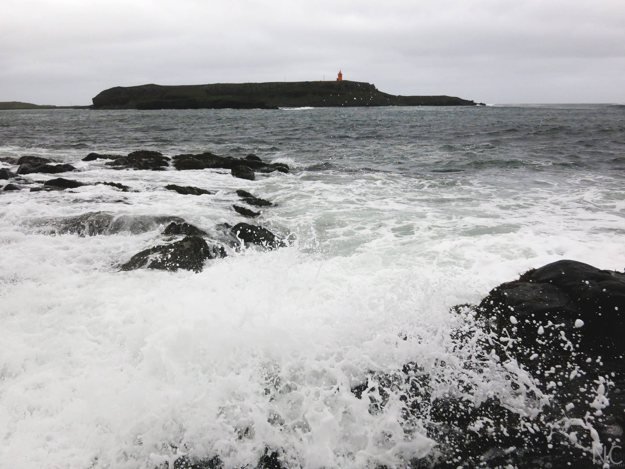 Raufarhafnarviti Lighthouse on the cliff above the Raufarhöfn coast.