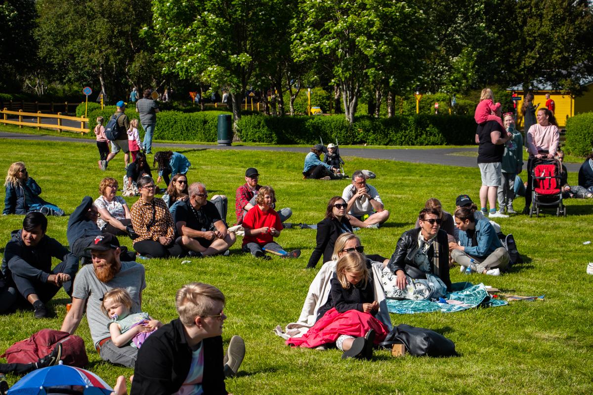 Families resting on the grass inside Reykjavík Family Park and Zoo in Laugardalur