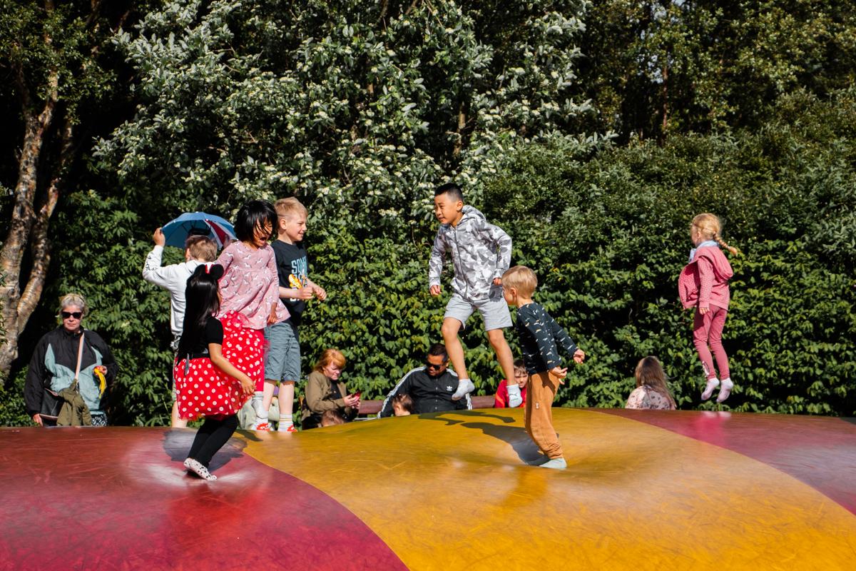 Children playing on a bouncy surface at Reykjavík Family Park and Zoo
