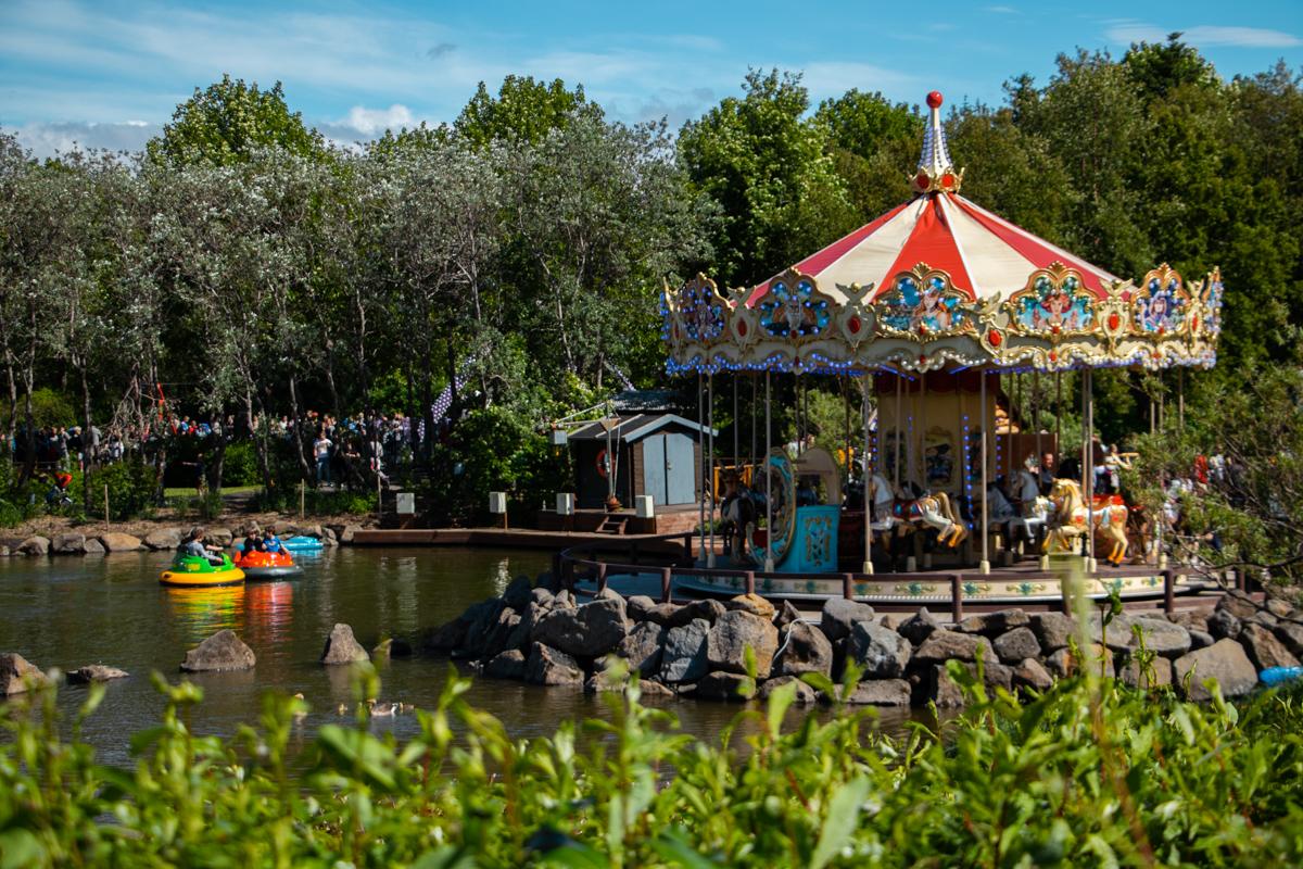 Carousel and small boats at Reykjavík Family Park and Zoo on a sunny summer day