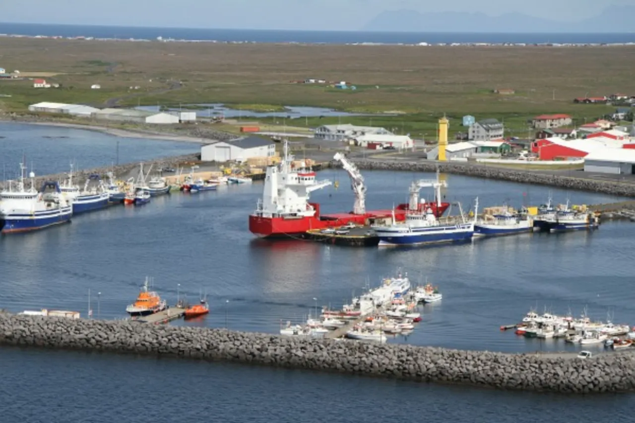 Fishing vessels and breakwaters inside Sandgerðishöfn harbor in Sandgerði.
