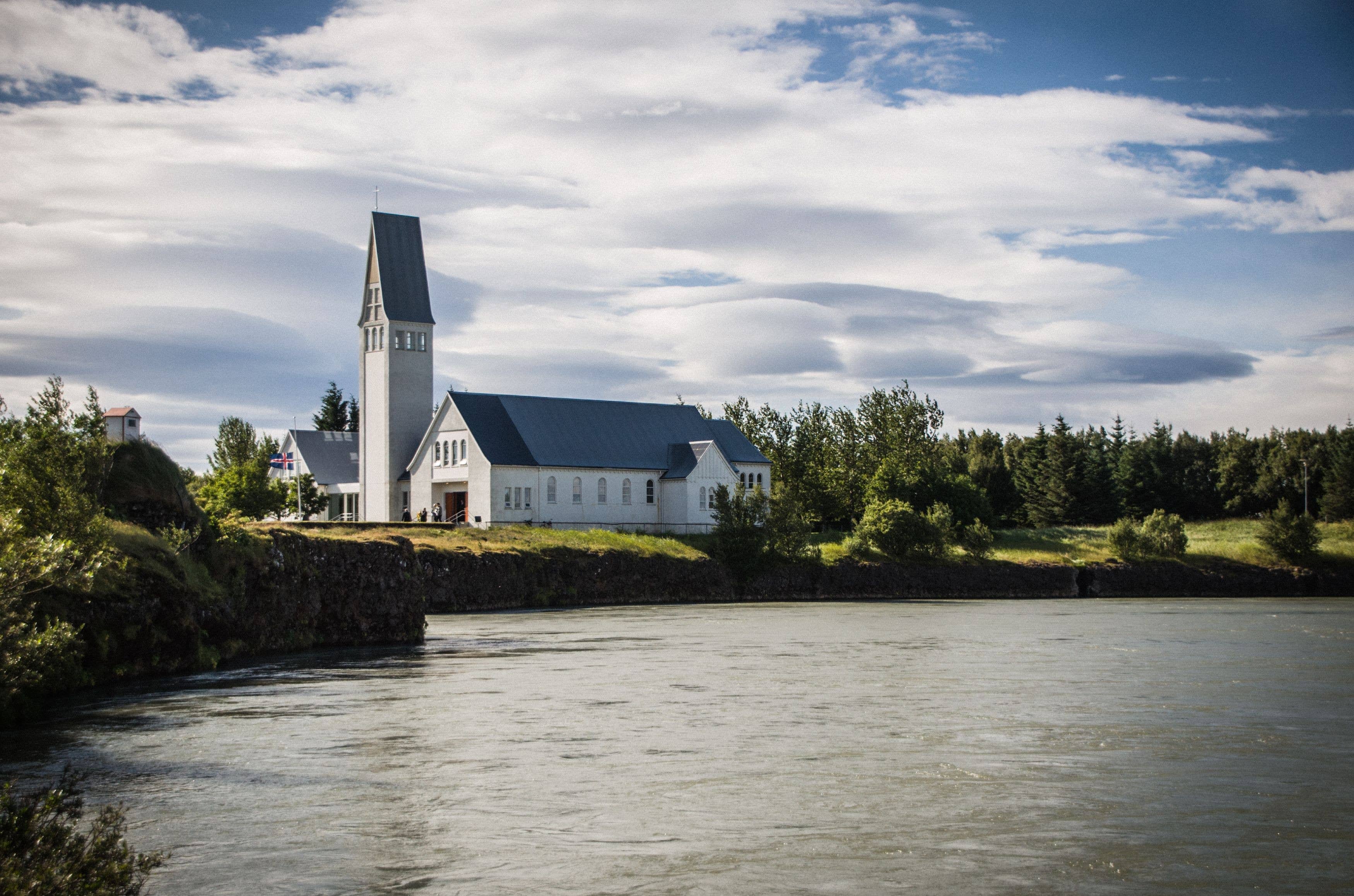 Selfoss Church above the riverbank in summer.