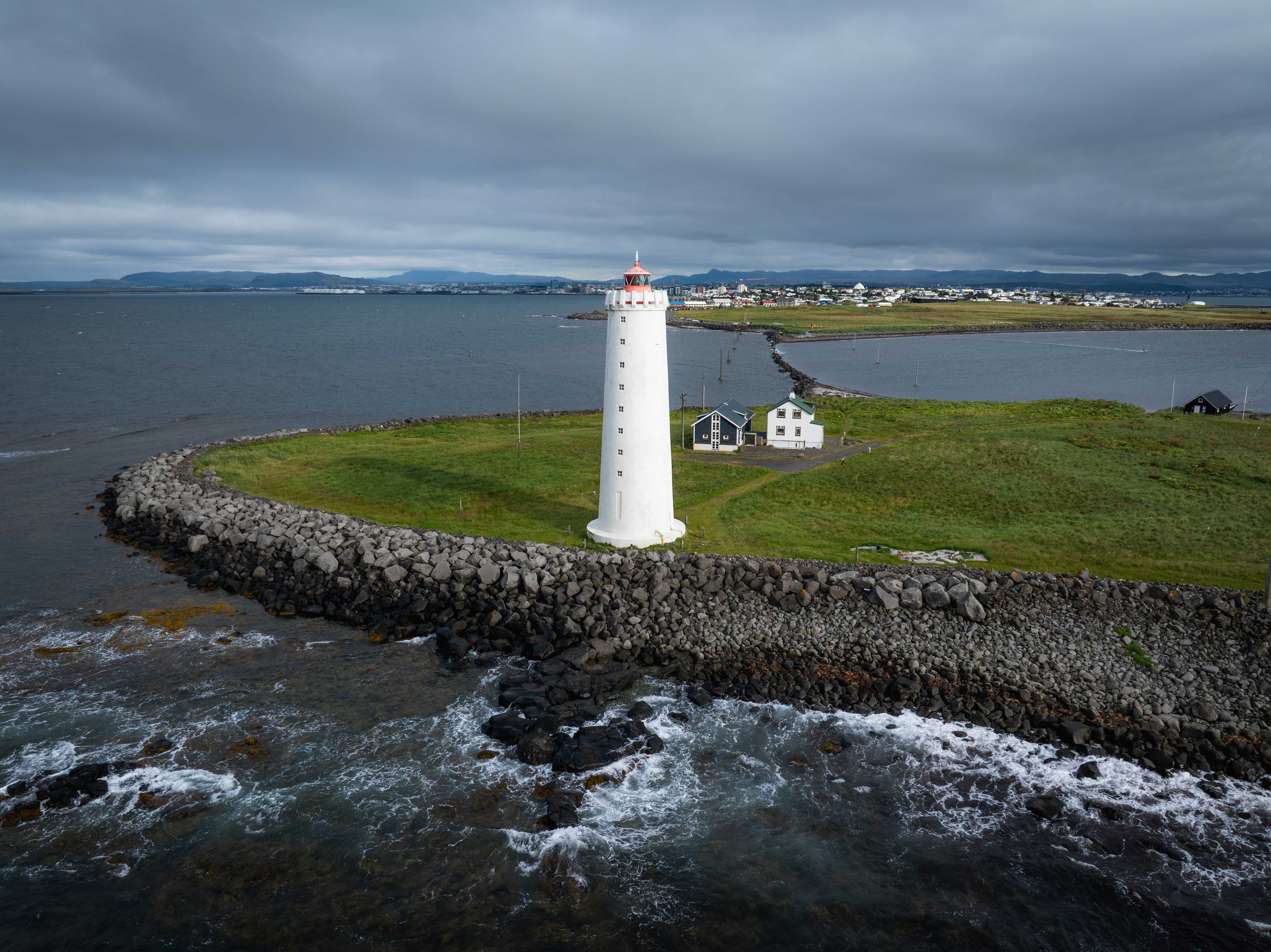 Grótta lighthouse surrounded by the rocky Seltjarnarnes shoreline