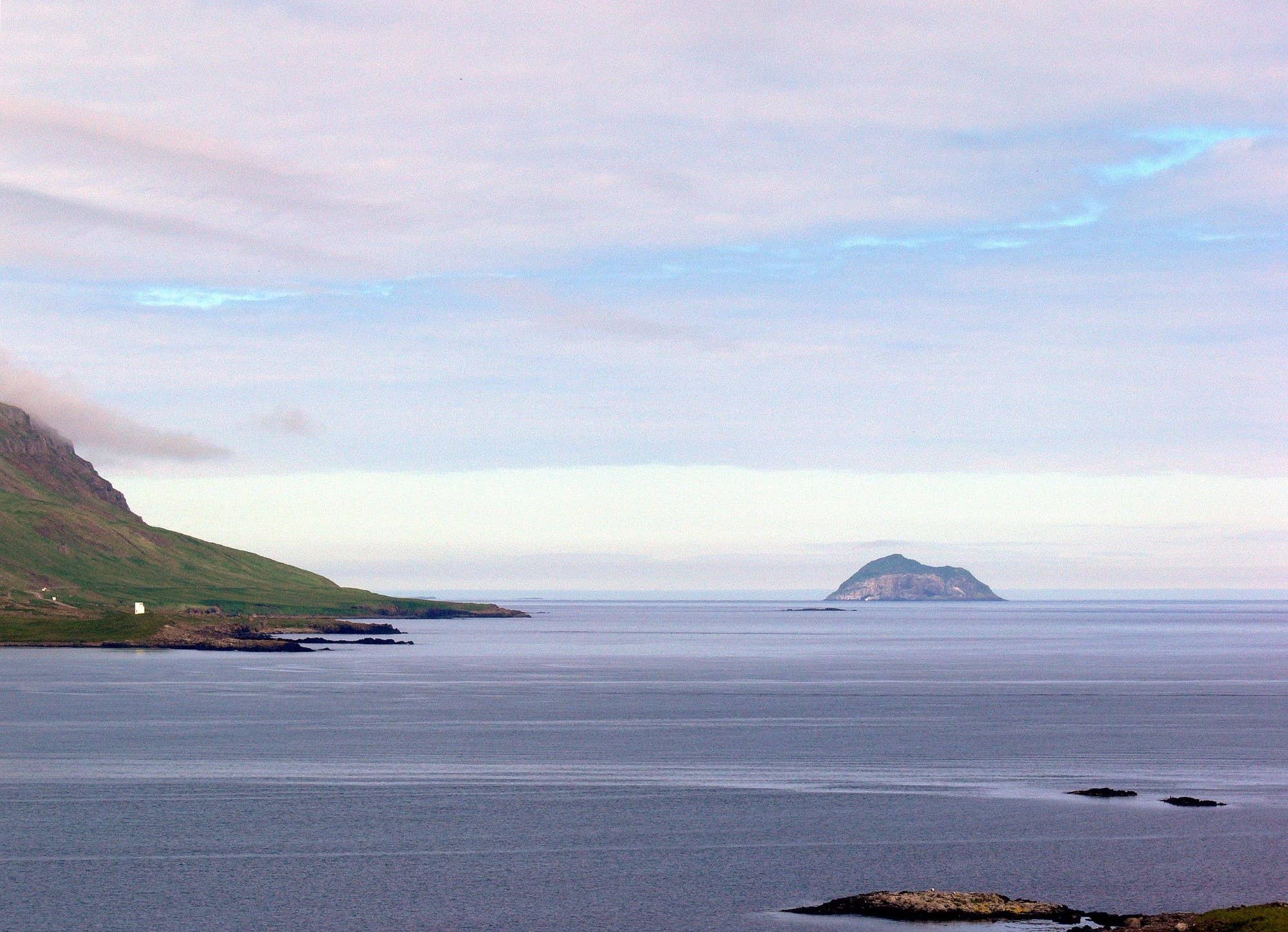 Skrúður island at the opening of Fáskrúðsfjörður with sea and mountains around it.