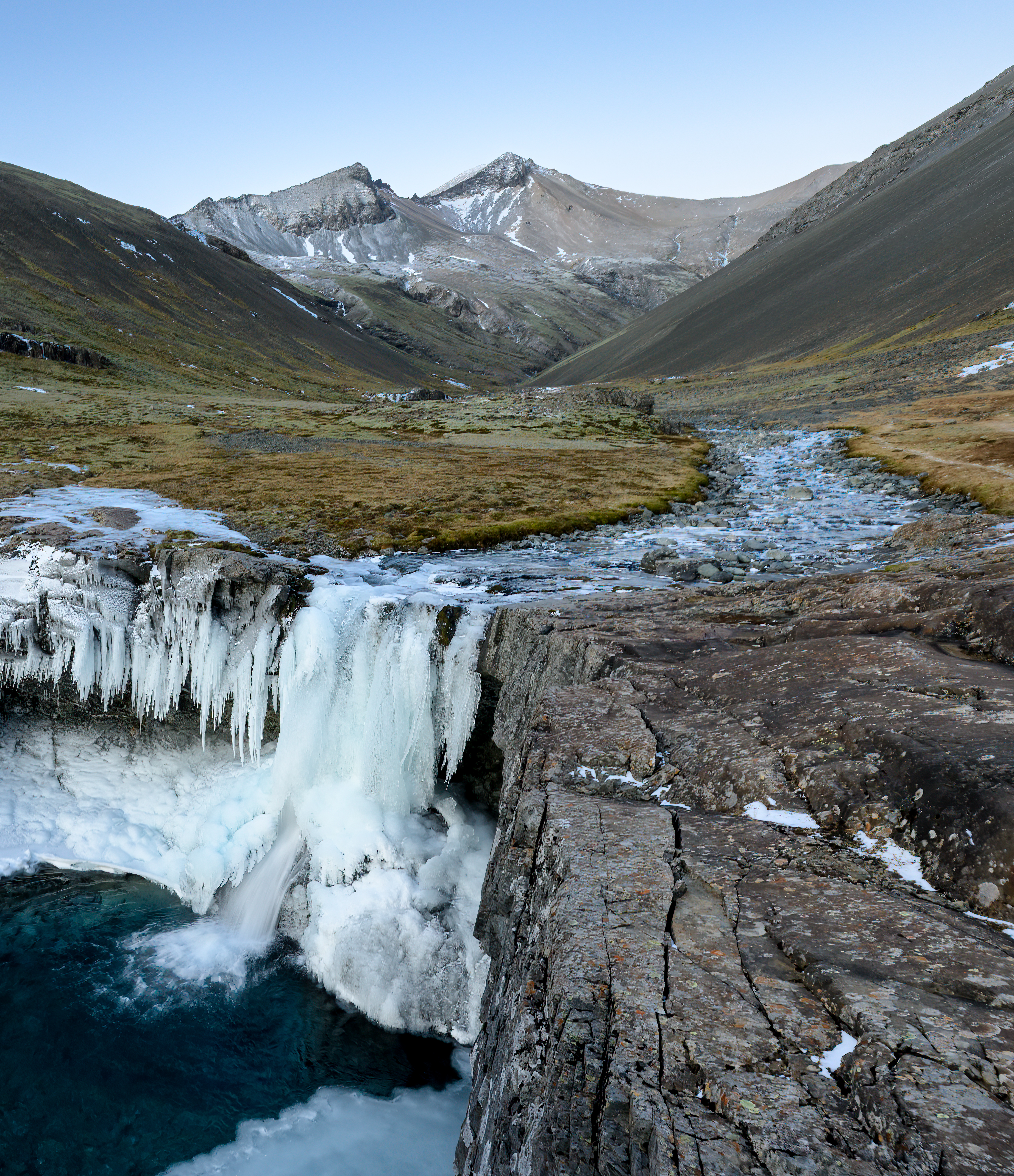 Winter river and frozen Skútafoss waterfall in the Hornafjörður area.