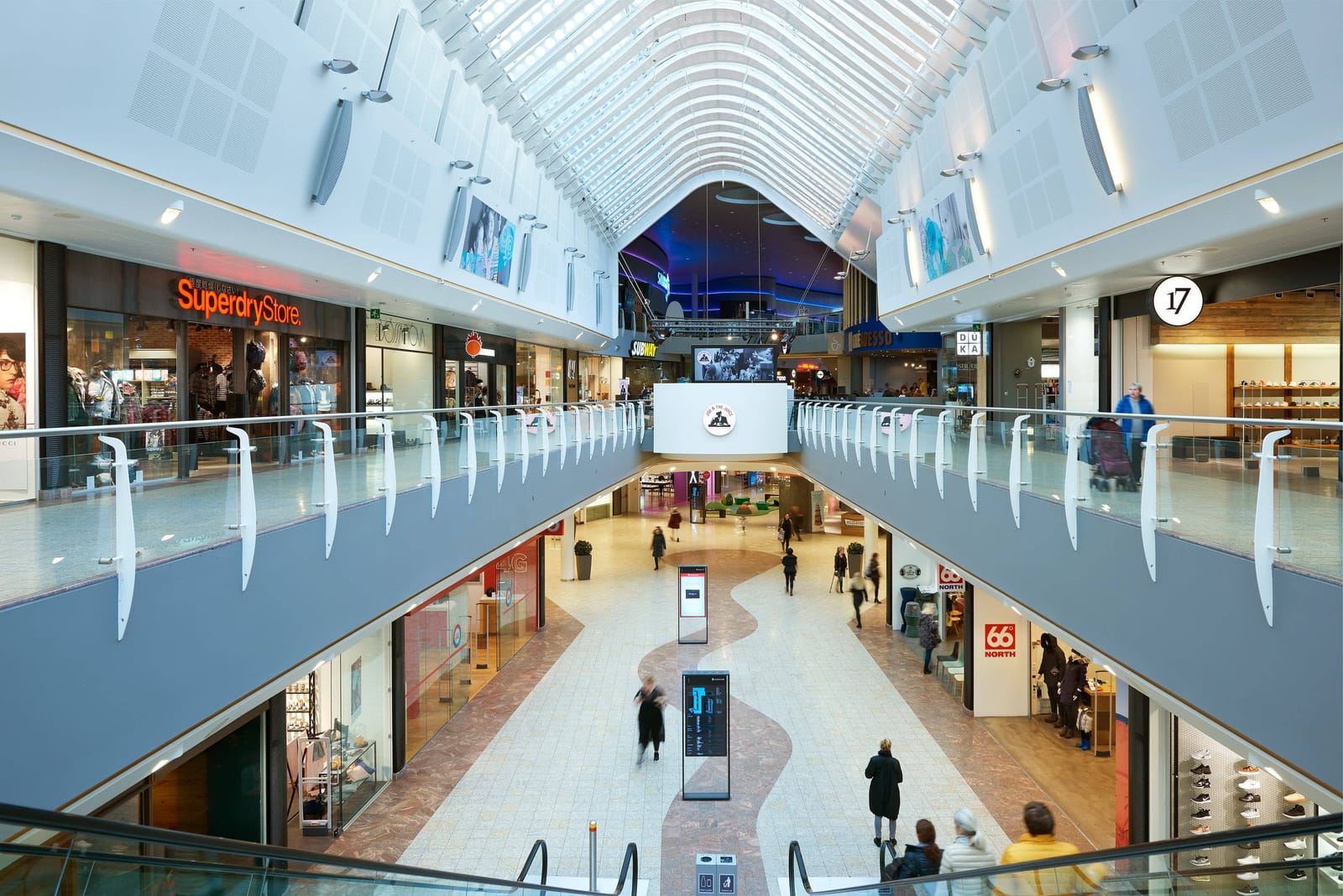 Bright atrium and upper walkways inside Smáralind Shopping Mall in Kópavogur.