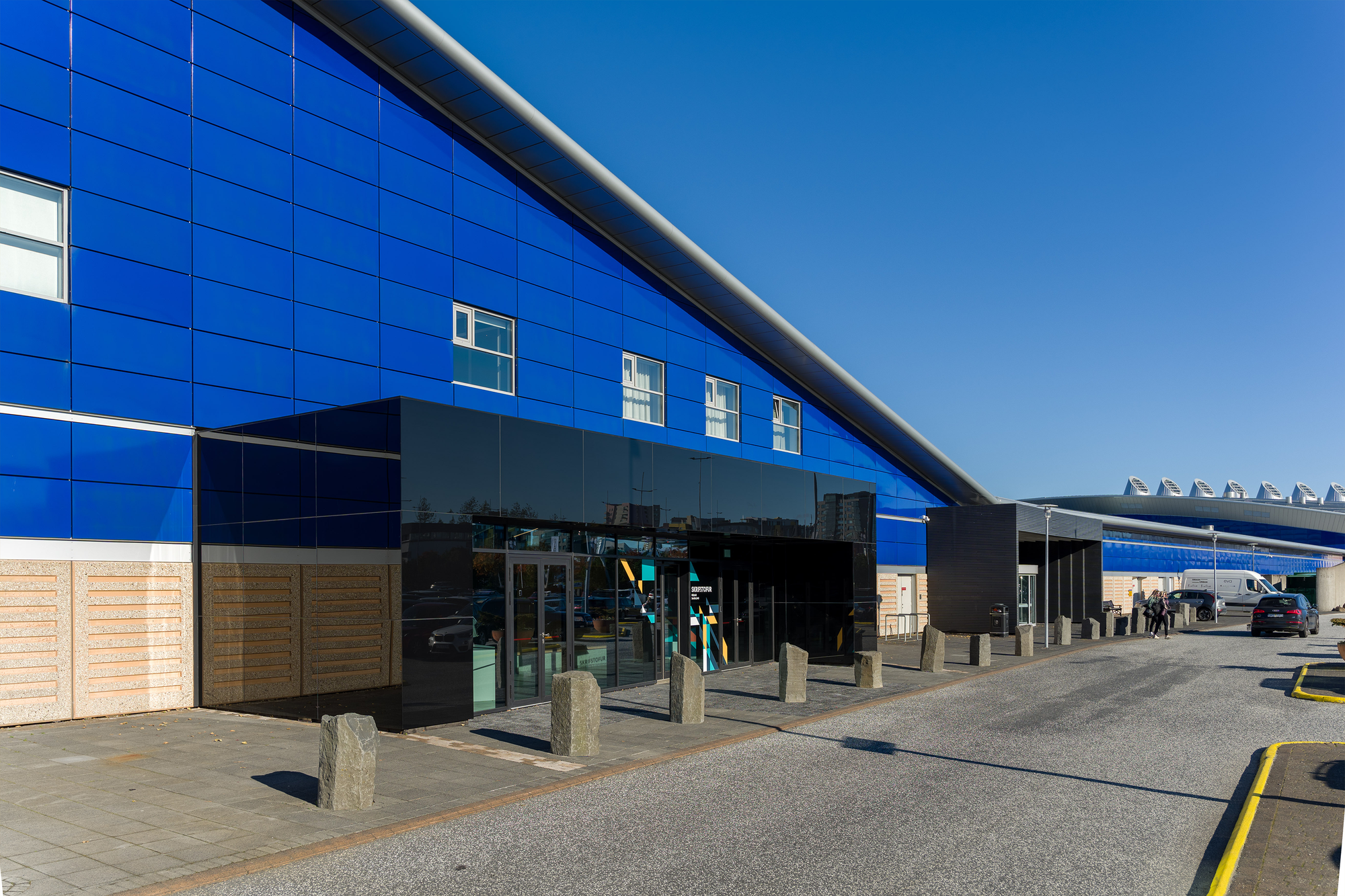 Blue exterior wall and entrance area at Smáralind Shopping Mall.
