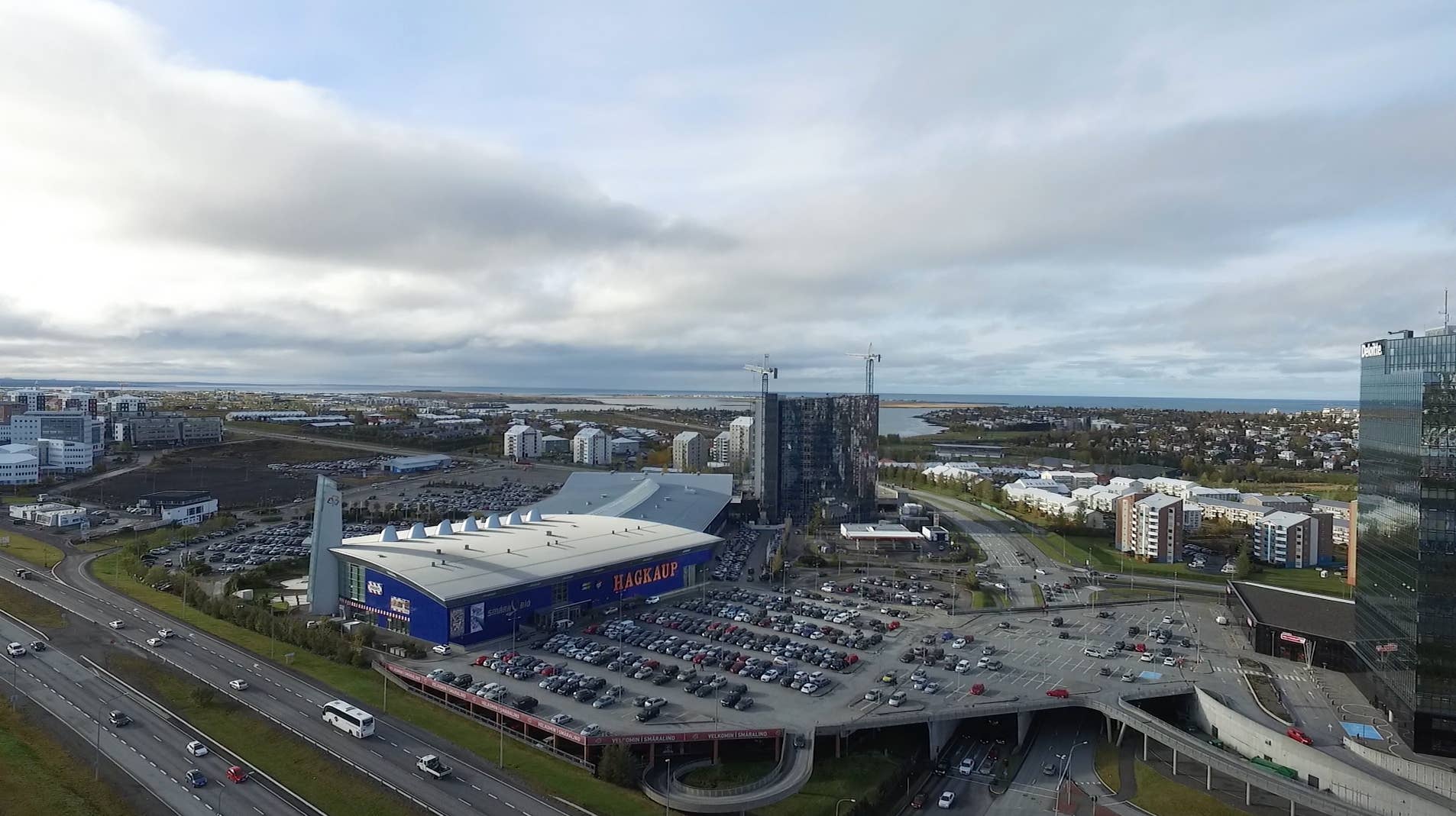Aerial view of Smáralind Shopping Mall, roads, and parking in Kópavogur.