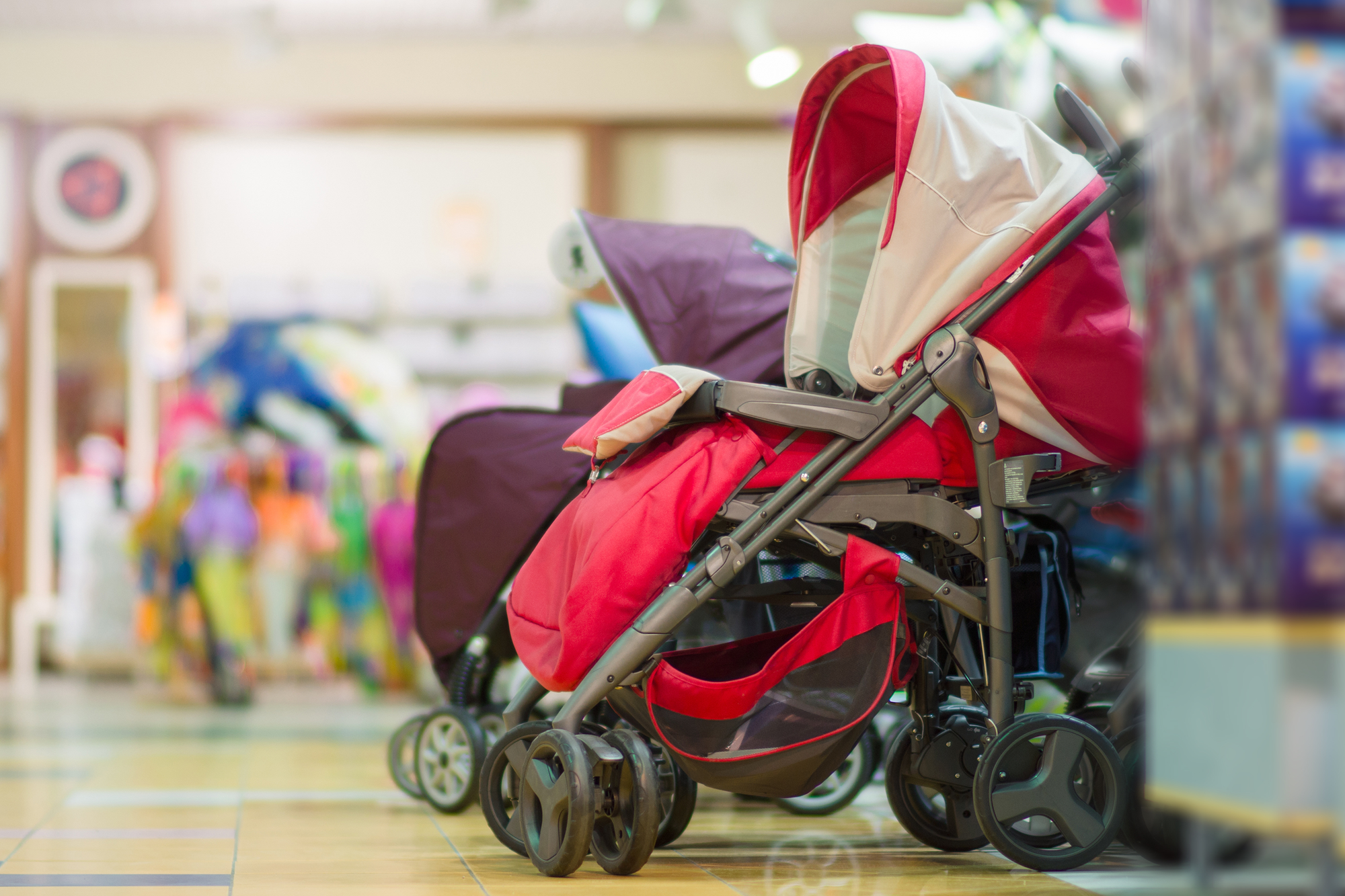 Child stroller inside a colorful family area at Smáralind.