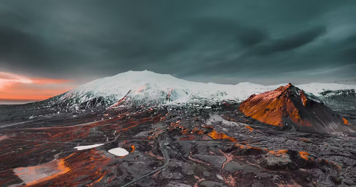 Snæfellsjökull and nearby Snæfellsnes mountains above grassy lowlands.