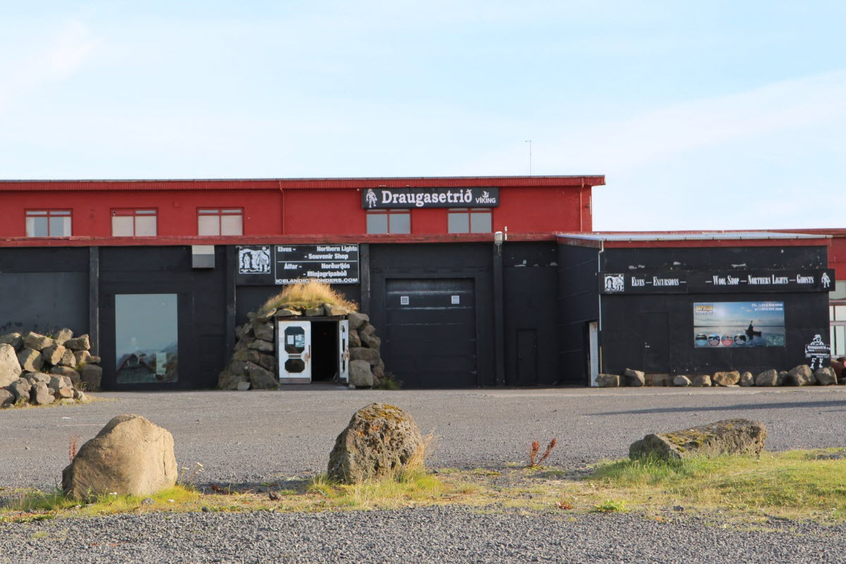 Red and black cultural-centre building in Stokkseyri with Ghost Center signs