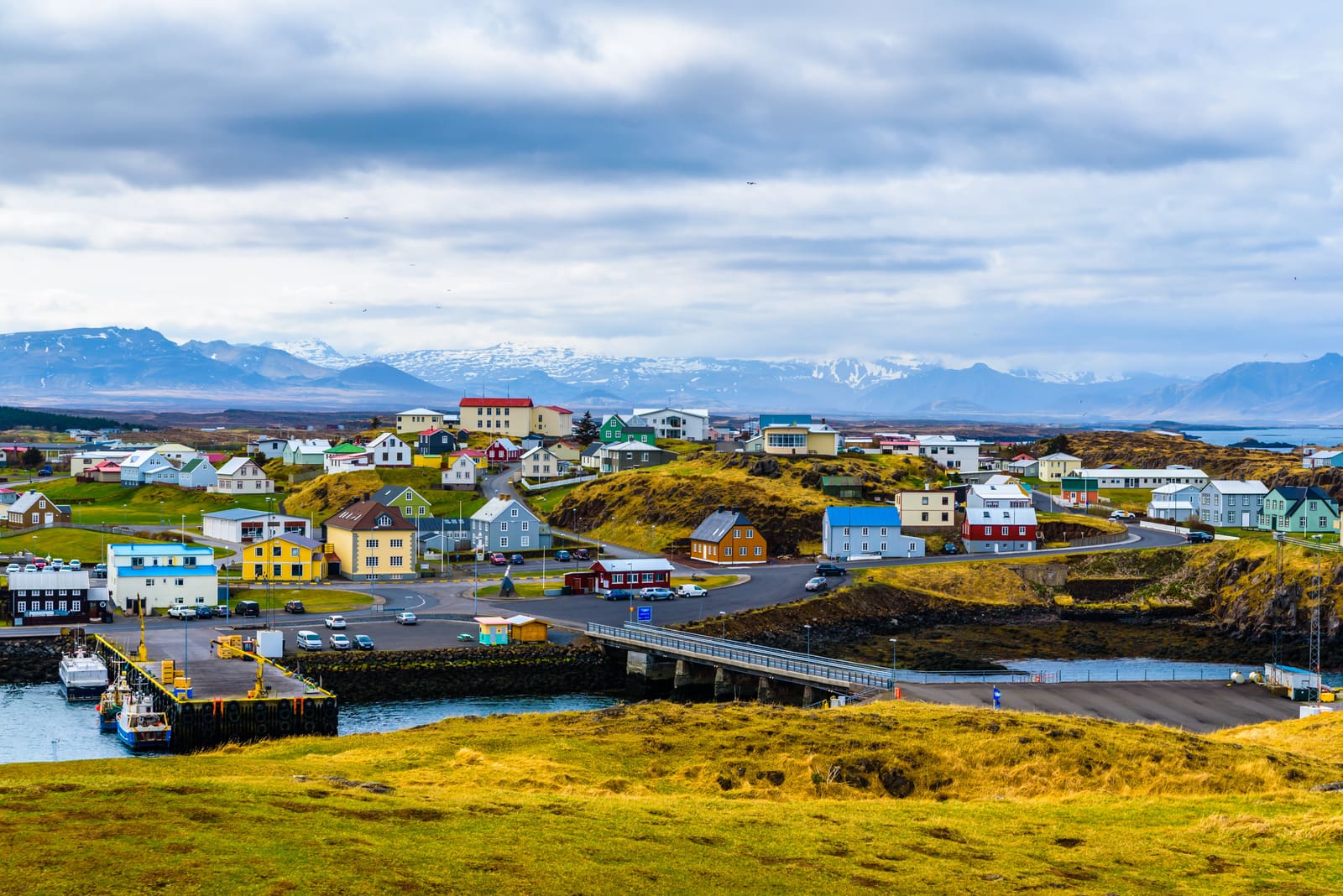 Colorful houses and harbor water in Stykkishólmur below the north Snæfellsnes mountains.