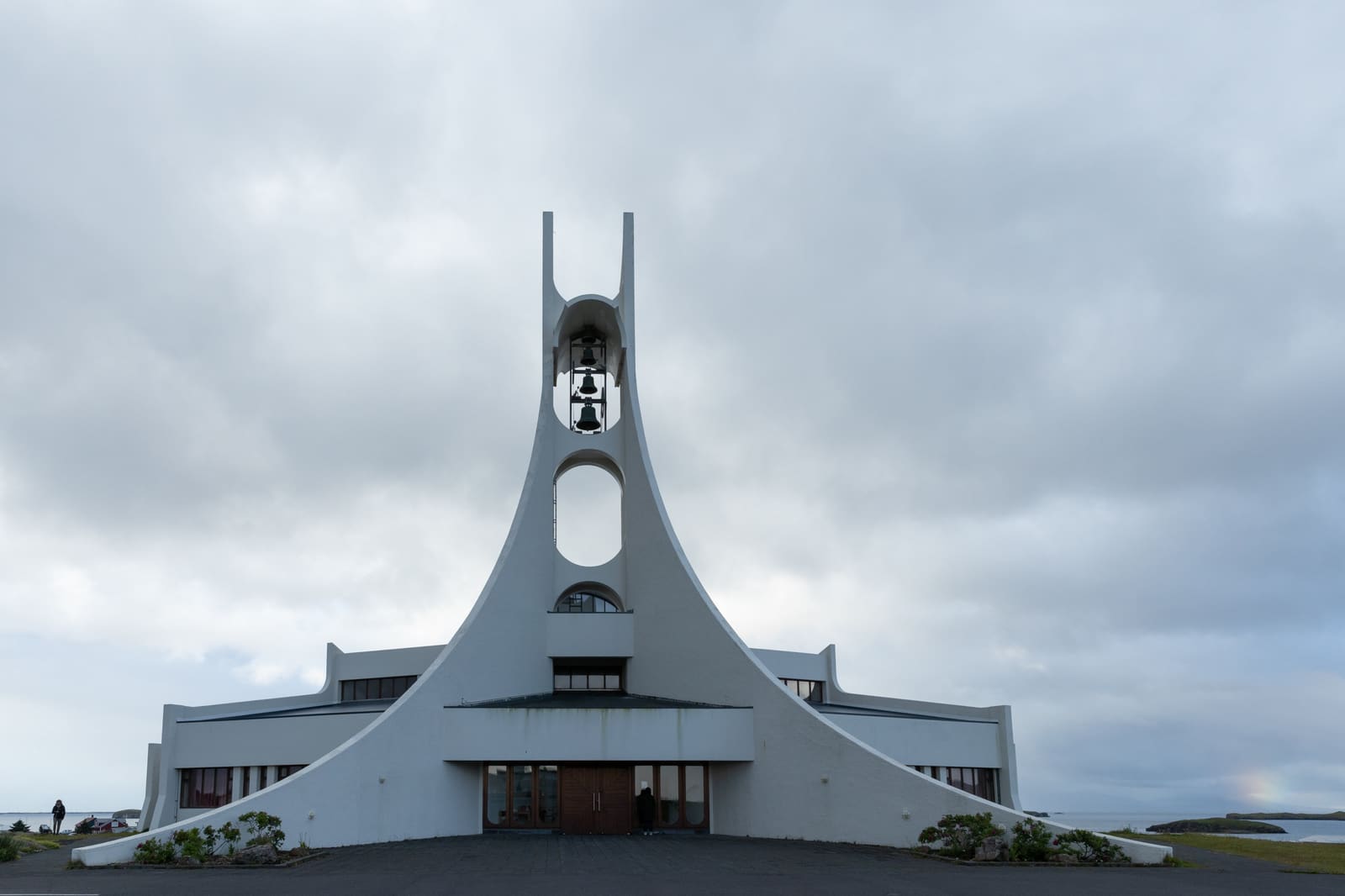 Front view of Stykkishólmskirkja Church with its white curved bell tower above Stykkishólmur.