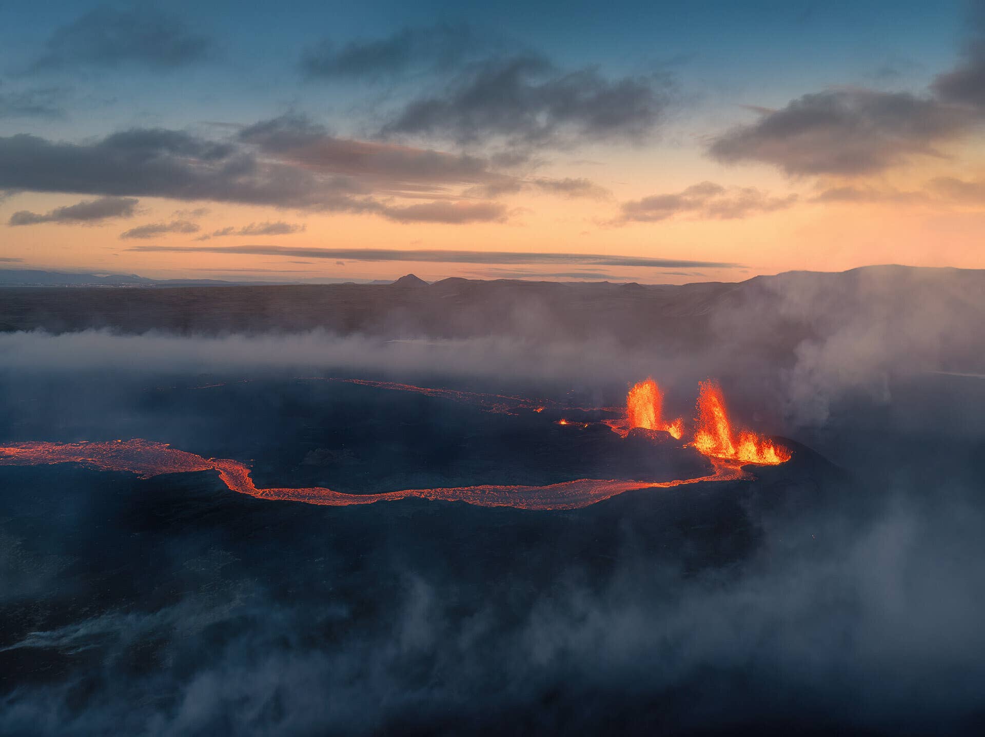 Fresh dark lava and steam in the Sundhnúkagígar volcanic area near Grindavík.