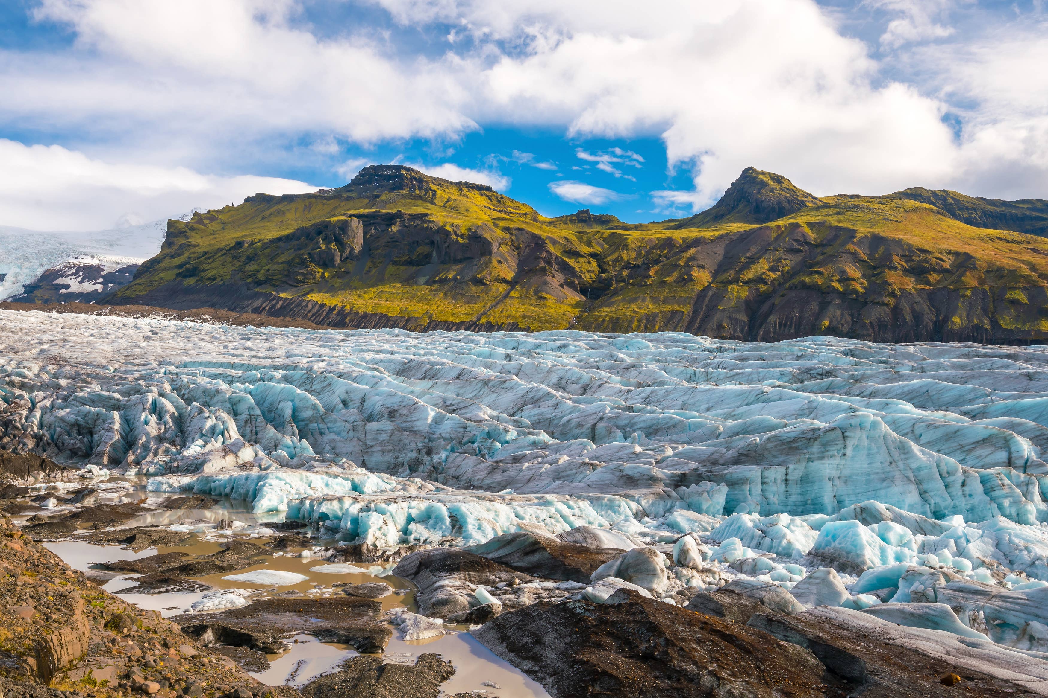 Svínafellsjökull flowing below rugged mountains in Vatnajökull National Park.