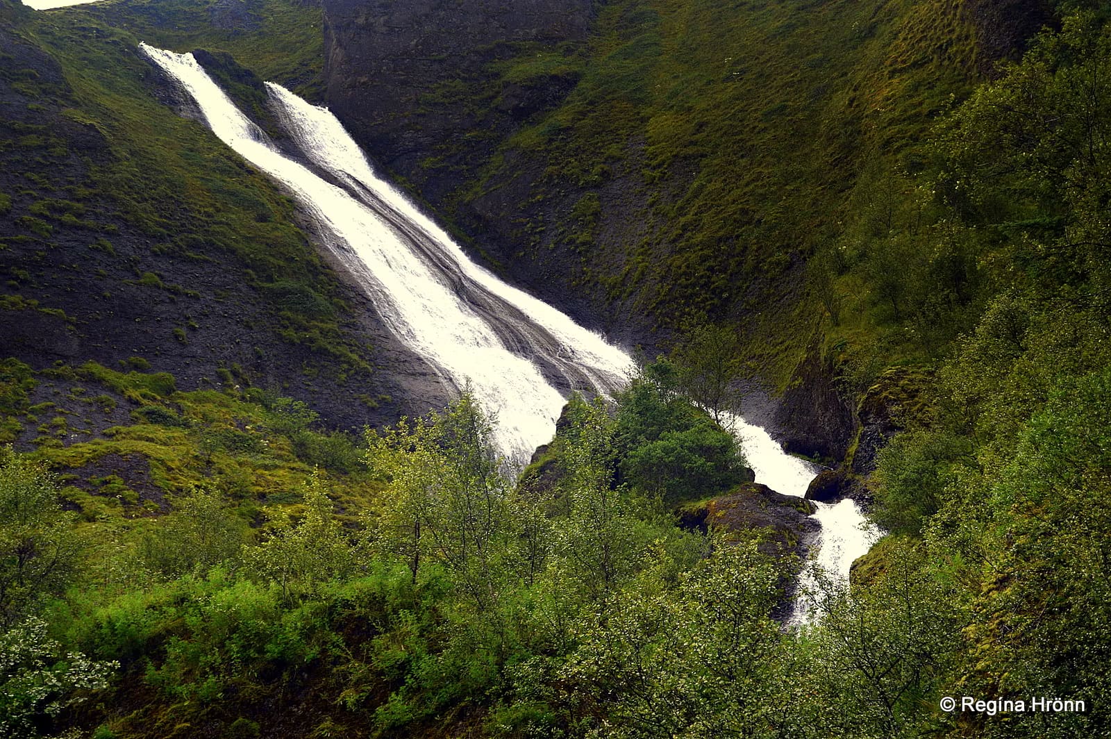 Systrafoss dropping in two narrow streams down the hillside above Kirkjubæjarklaustur.