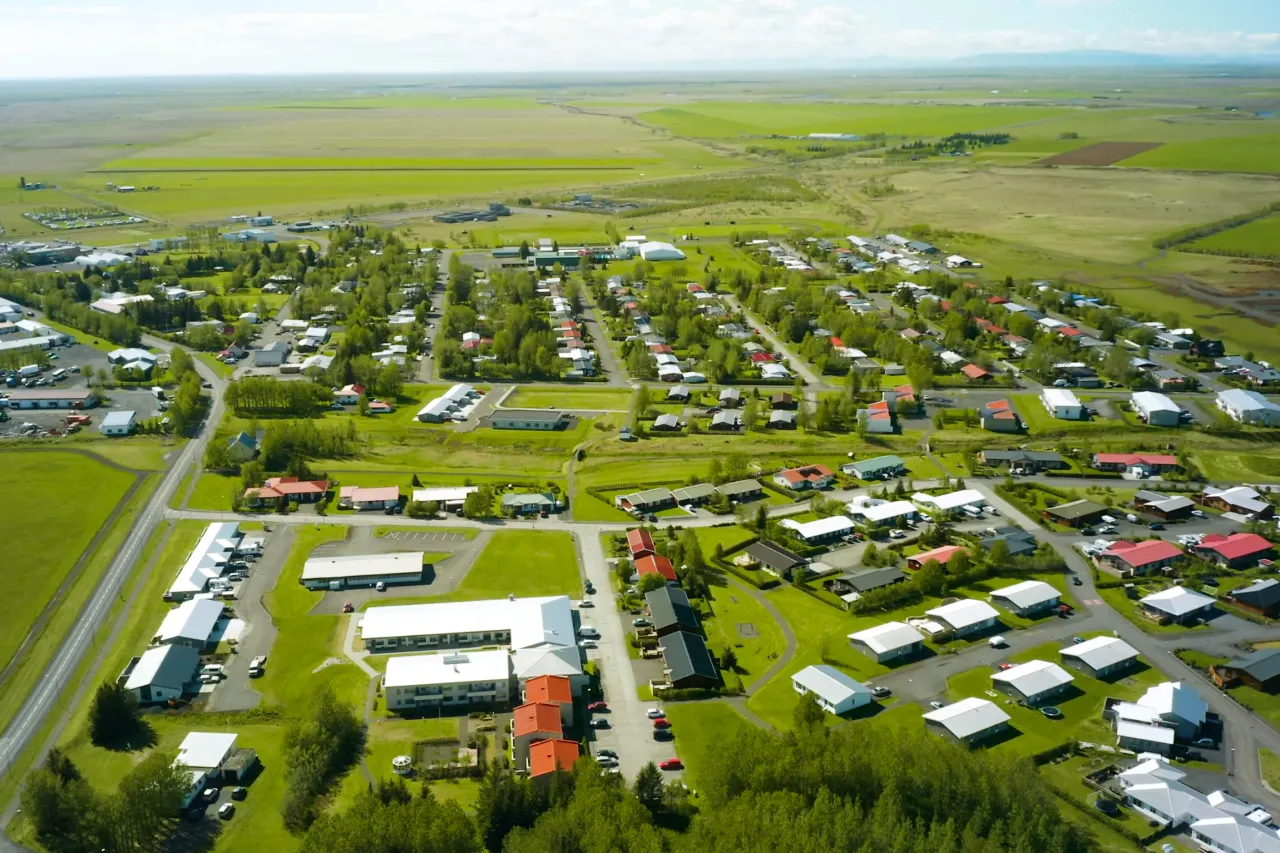 Hvolsvöllur town blocks and open South Iceland farmland seen from above.