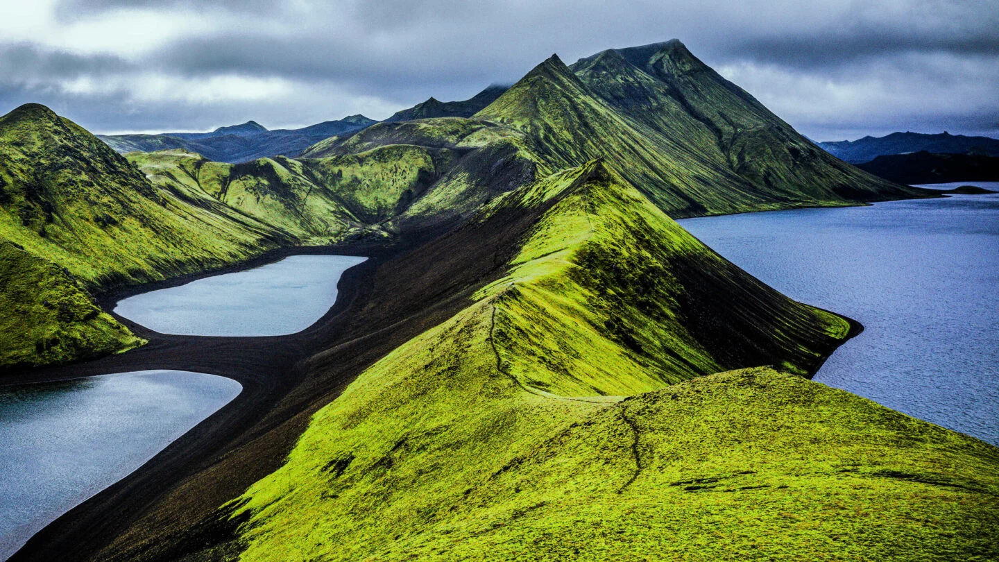 Green ridge and blue Langisjór lake near the Uxatindar highland route.