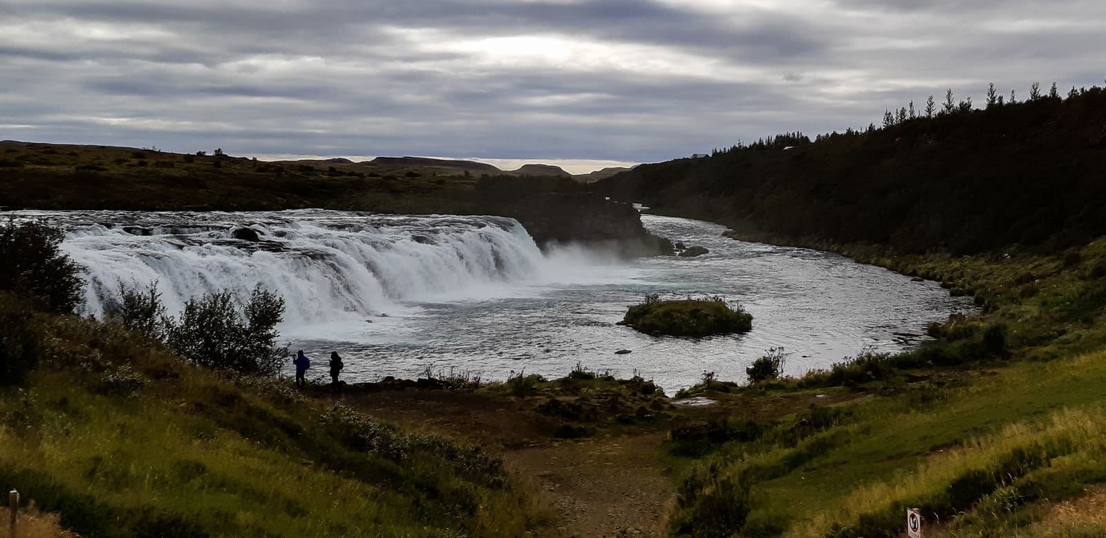 Panoramic view of Faxi or Vatnsleysufoss with people near the viewing area.