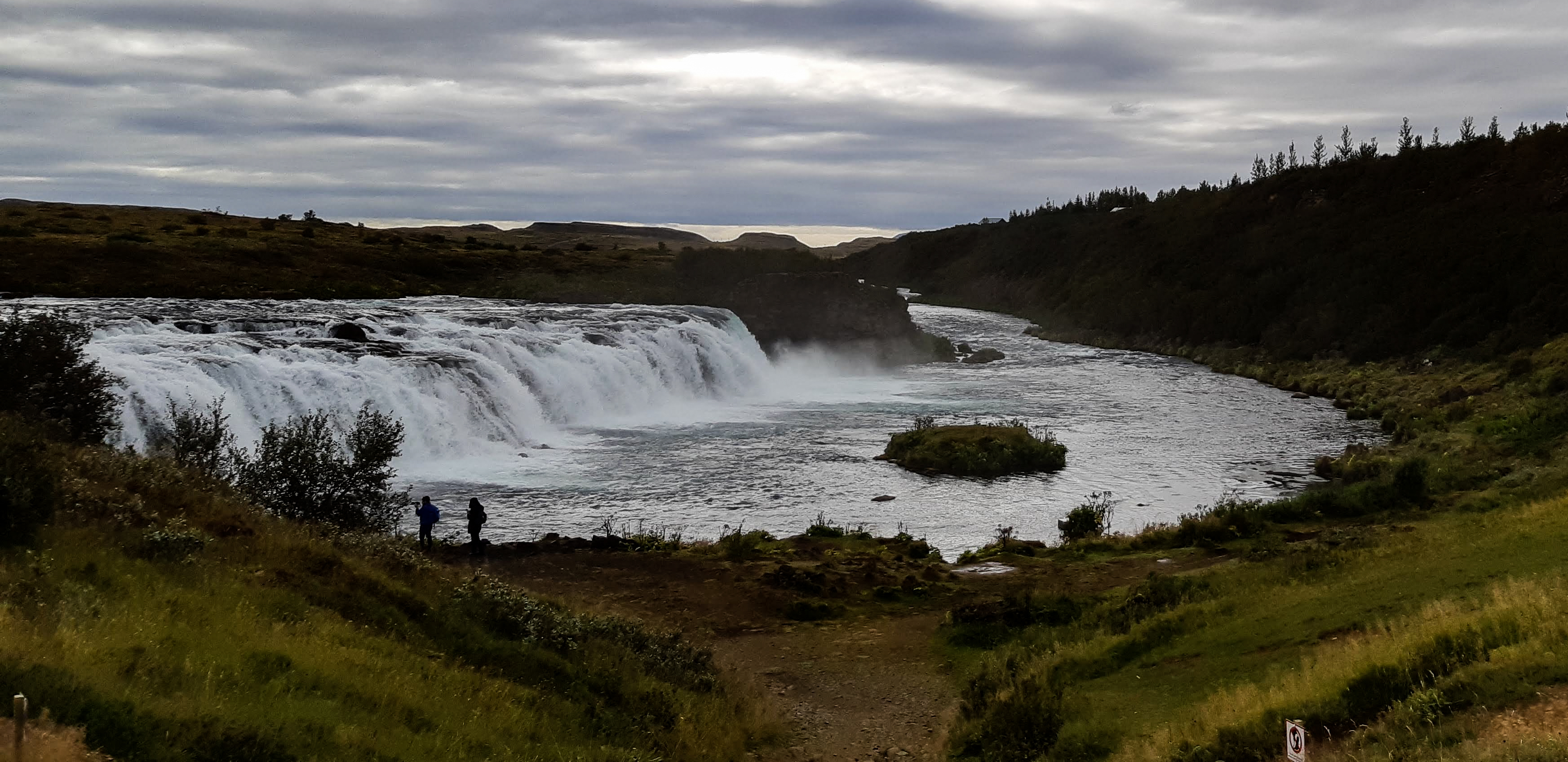 Panoramic view of Faxi or Vatnsleysufoss with people near the viewing area.