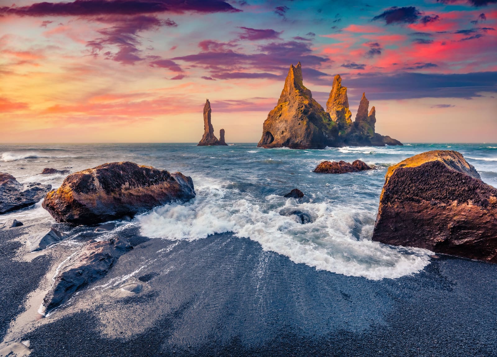 Reynisdrangar sea stacks seen near the hilltop church area in Vík