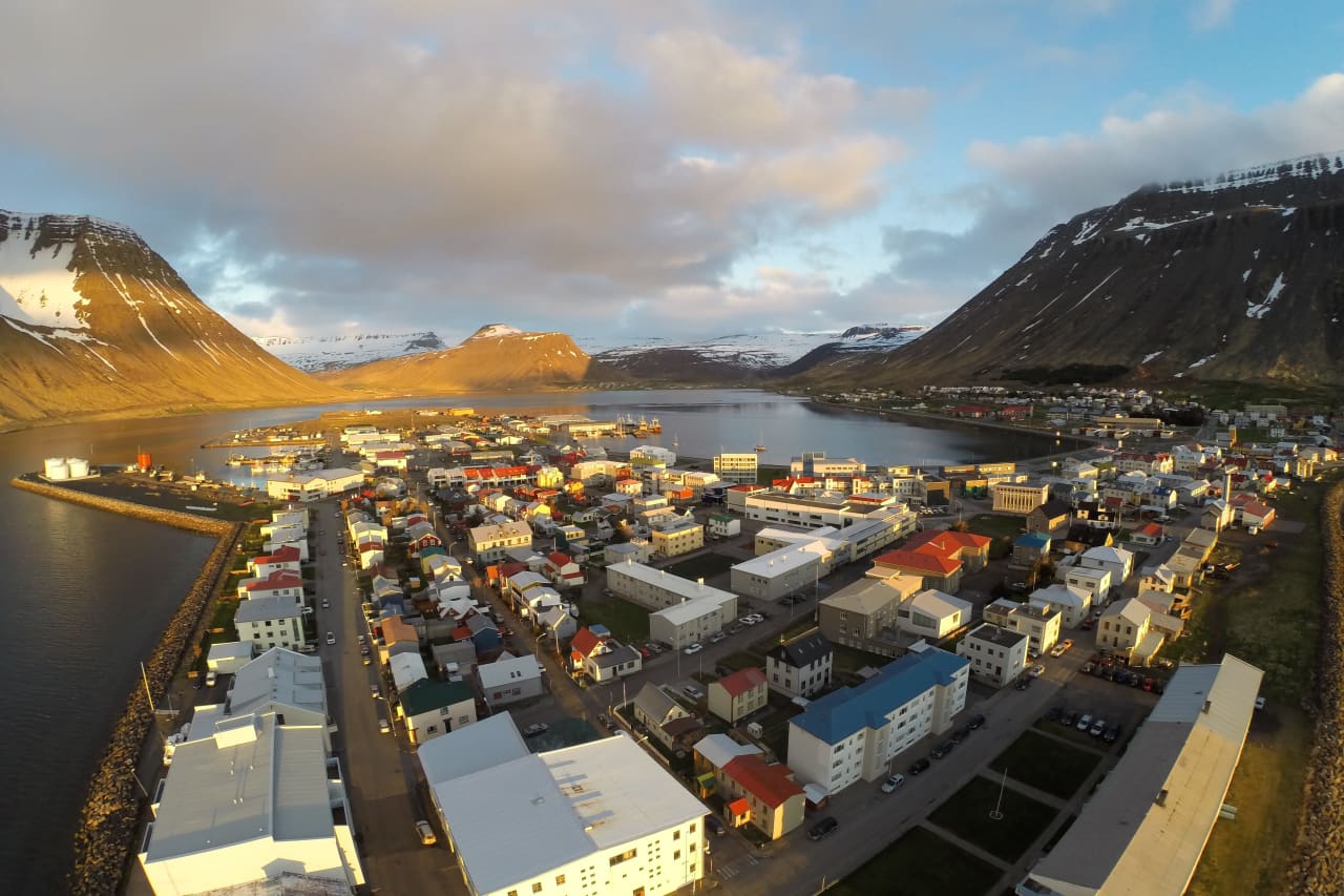 Aerial view of Ísafjörður between steep Westfjords mountains and the fjord.