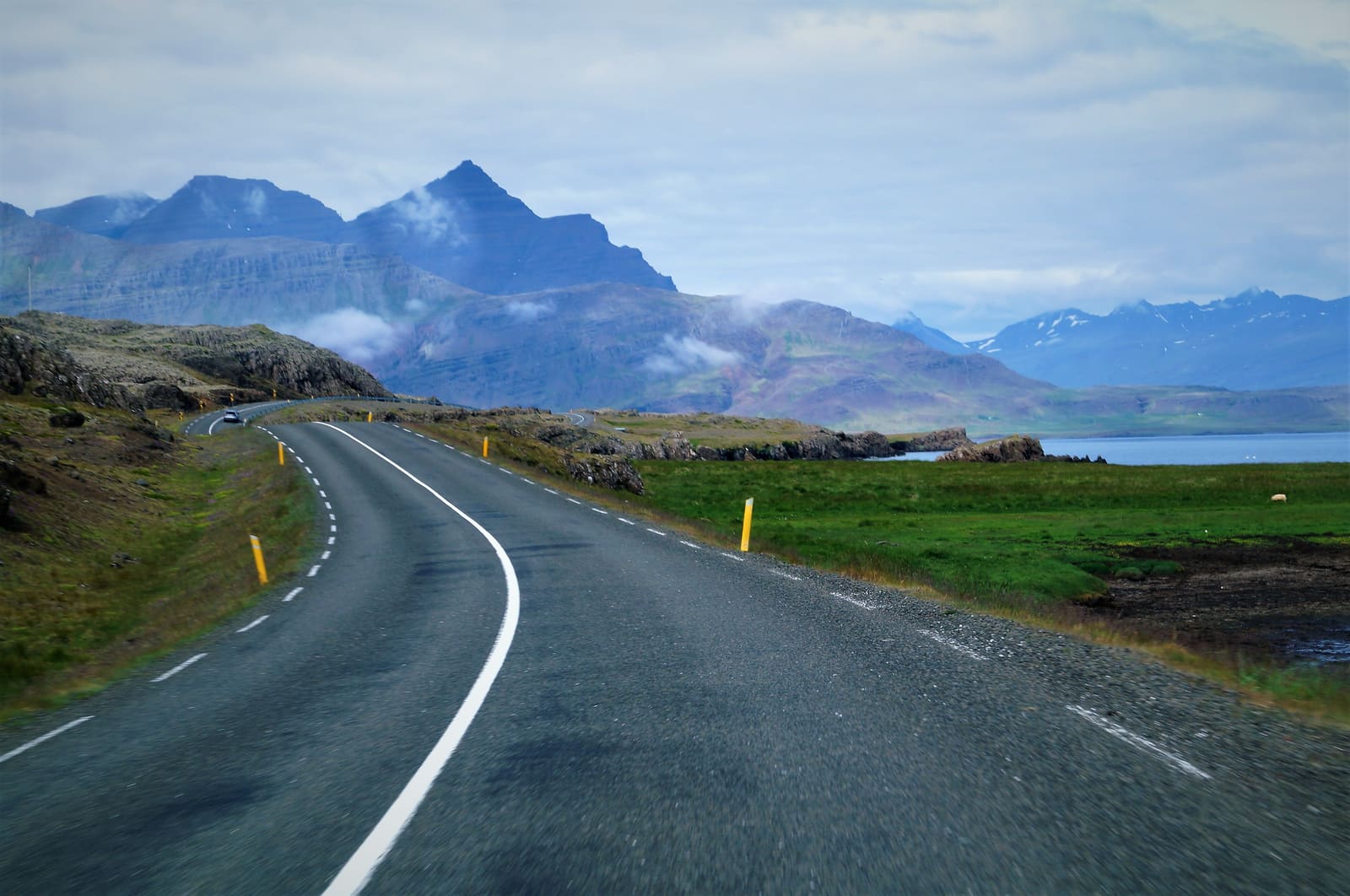 Route 1 curving beside Hamarsfjörður below layered East Iceland mountains