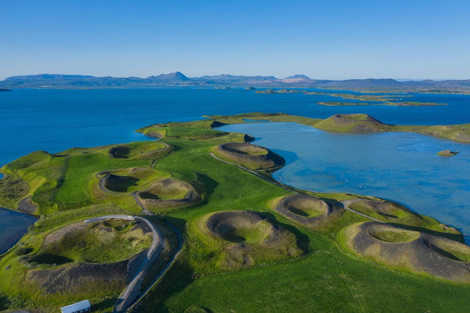 Aerial view over Lake Mývatn with islands and pseudo-craters on the Diamond Circle route.