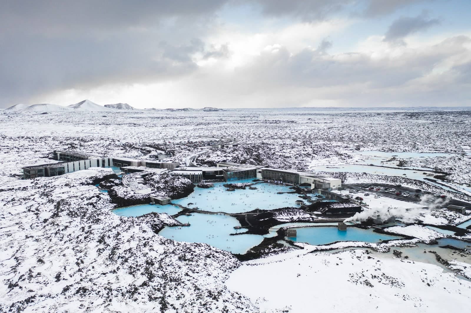 Aerial view of Blue Lagoon water and black lava fields near Keflavik Airport.
