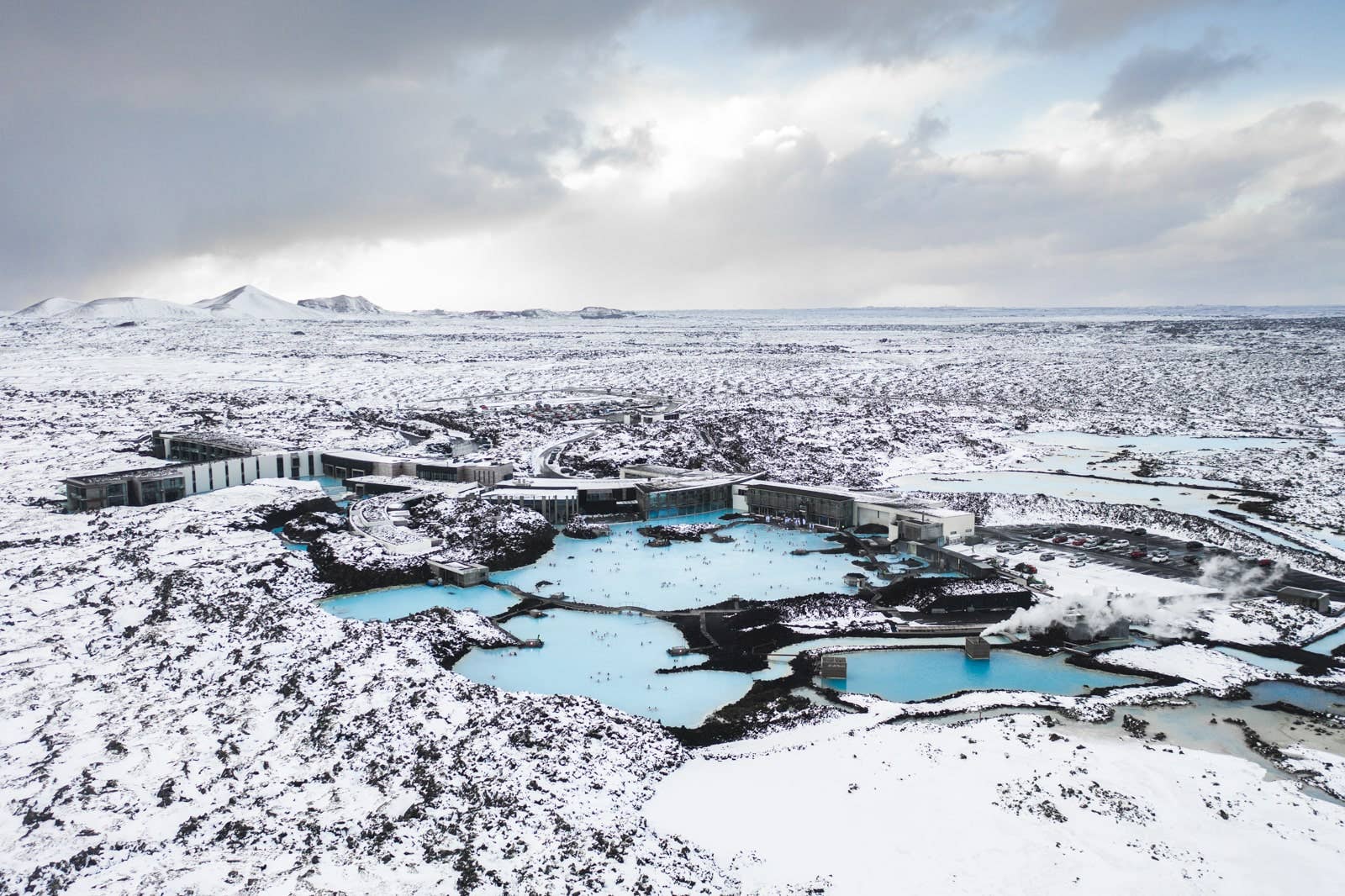 Aerial view of Blue Lagoon water and black lava fields near Keflavik Airport.
