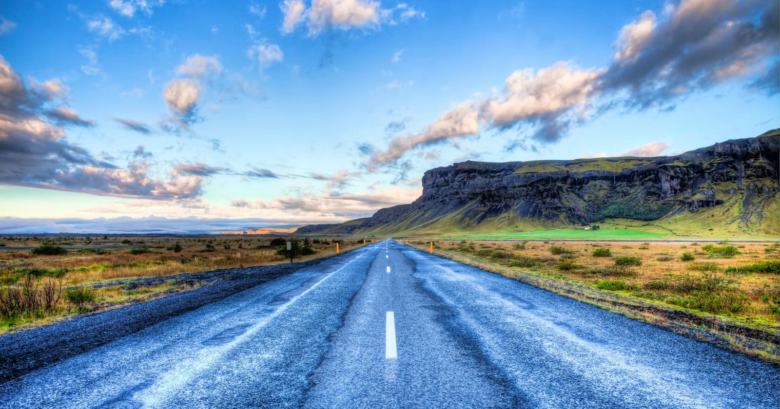 Open Iceland road through a broad landscape for a Ring Road or South Coast route decision
