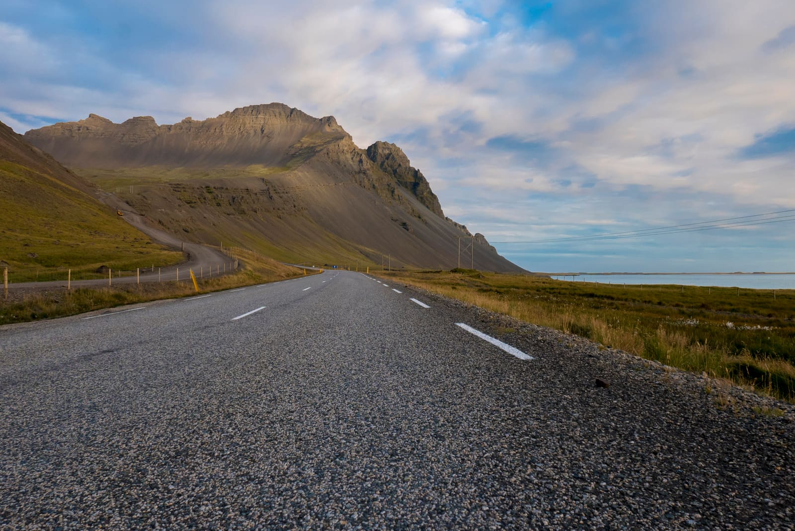 Paved road between mountains and the sea in Iceland's Eastfjords