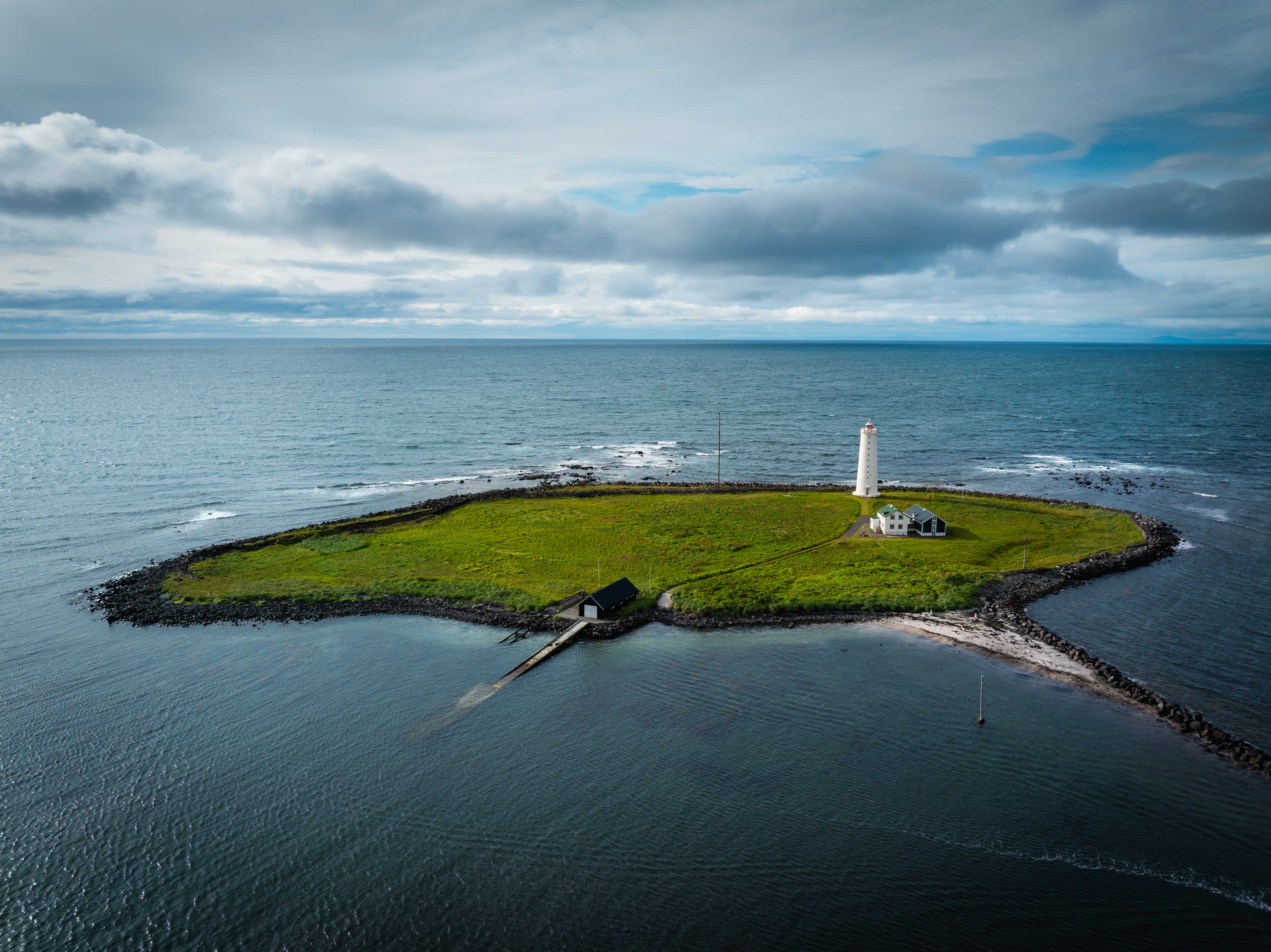 Grótta lighthouse surrounded by the low tidal Seltjarnarnes coast