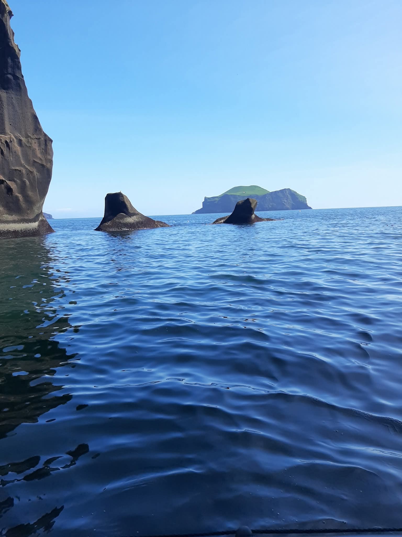 Low water-level view of rock stacks and islands off Heimaey