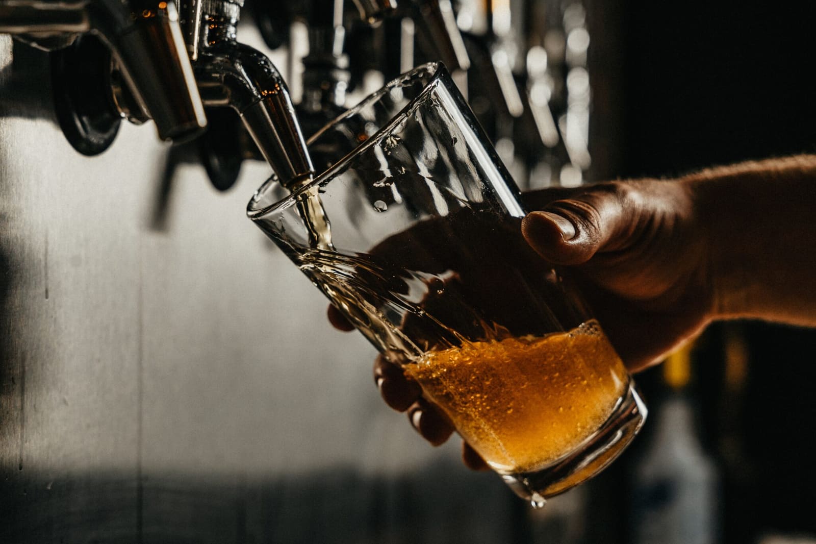 Beer pouring from a brewery tap into a tilted glass in Iceland