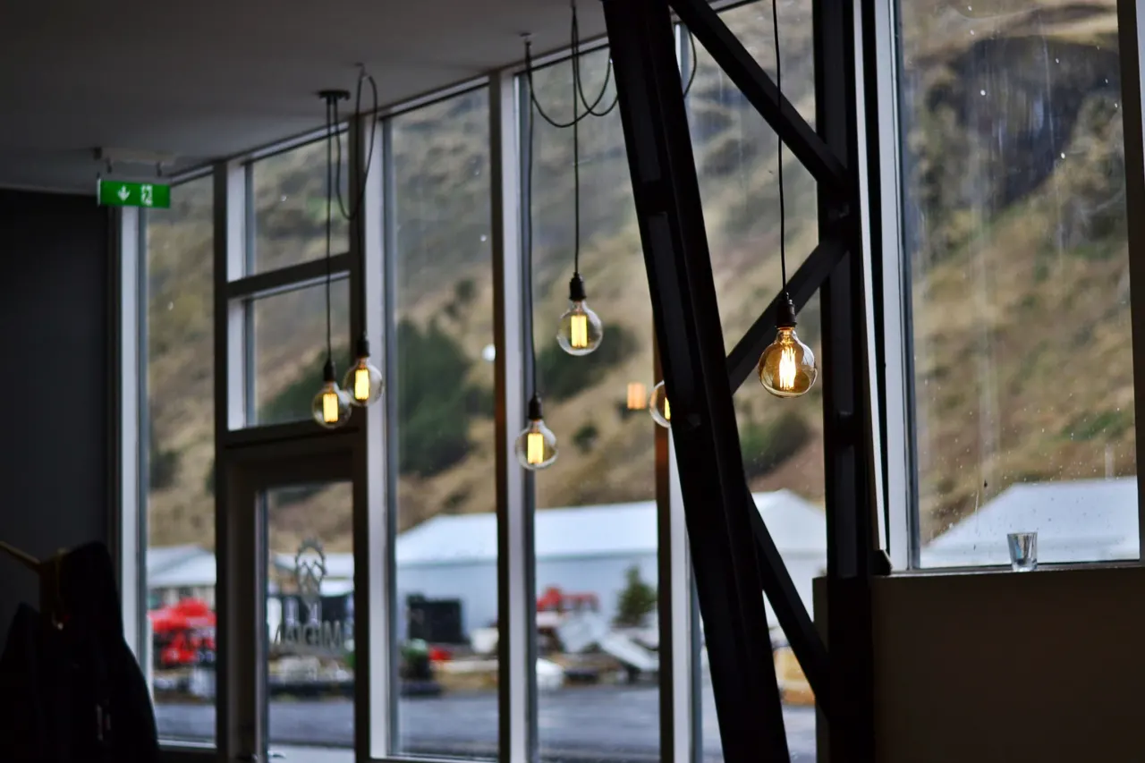 Brewery tasting-room windows facing a hillside in Vík, South Iceland