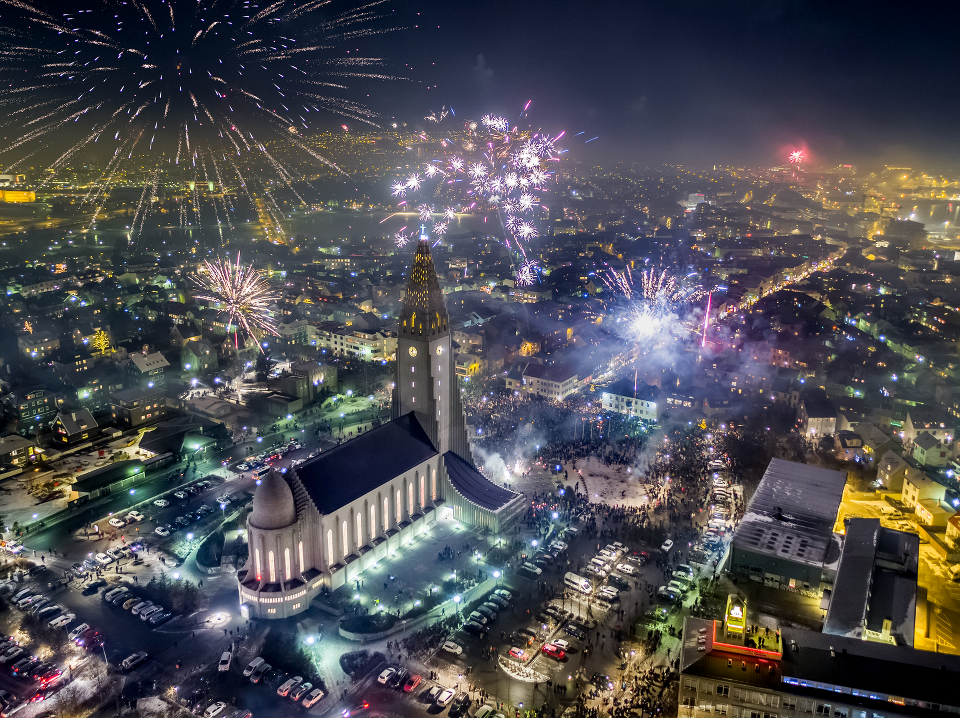 Fireworks and smoke spreading across Reykjavík around Hallgrímskirkja on New Year’s Eve