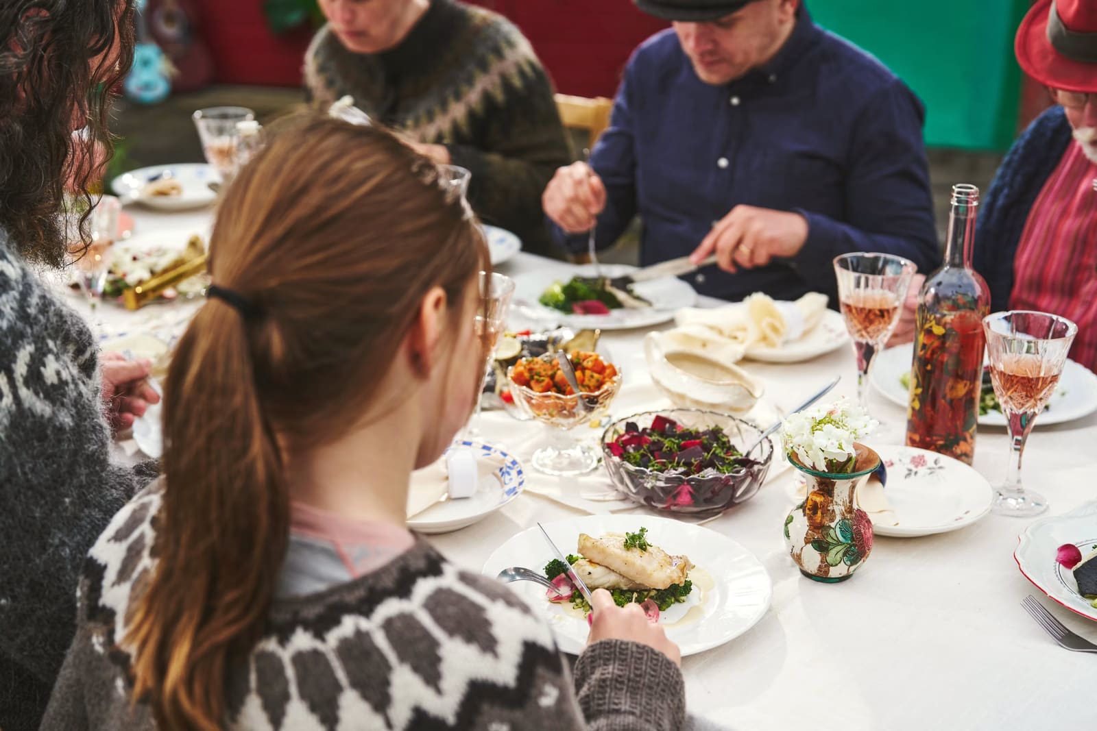 People sharing fish and other Icelandic dishes around a dining table