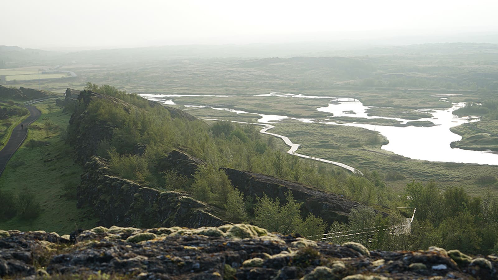 Visitors following the marked Almannagjá path between rock walls at Þingvellir National Park