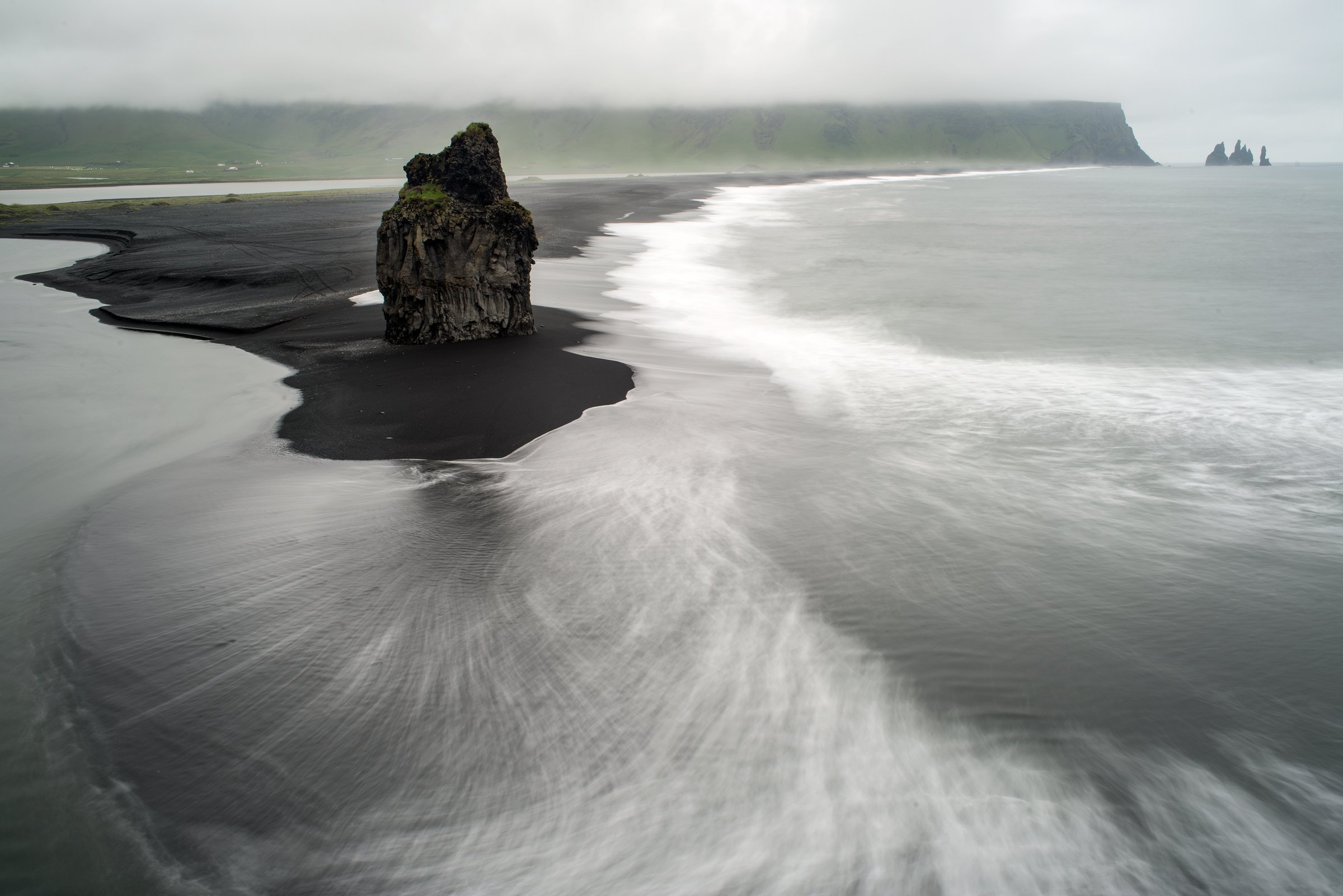 Reynisfjara black beach, Atlantic water, and Reynisdrangar sea stacks on Iceland's South Coast