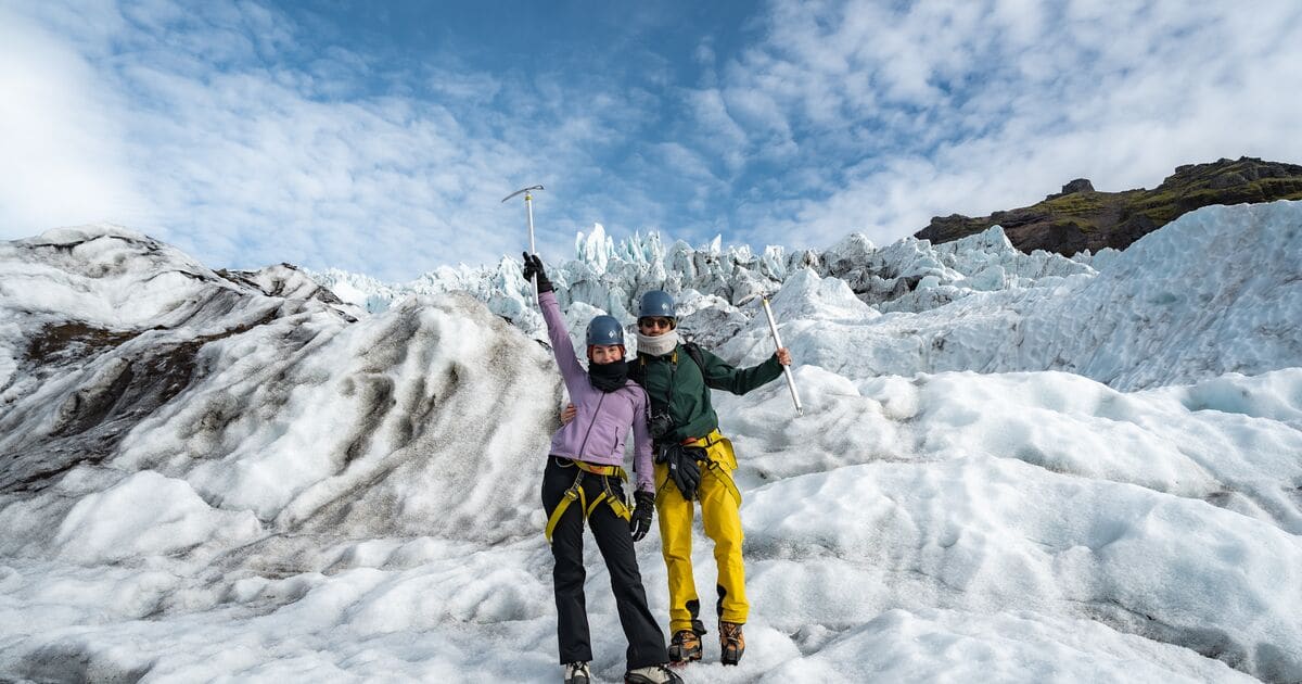 A glacier guide prepares a small group with crampons and ice axes before heading onto the glacier in Skaftafell.