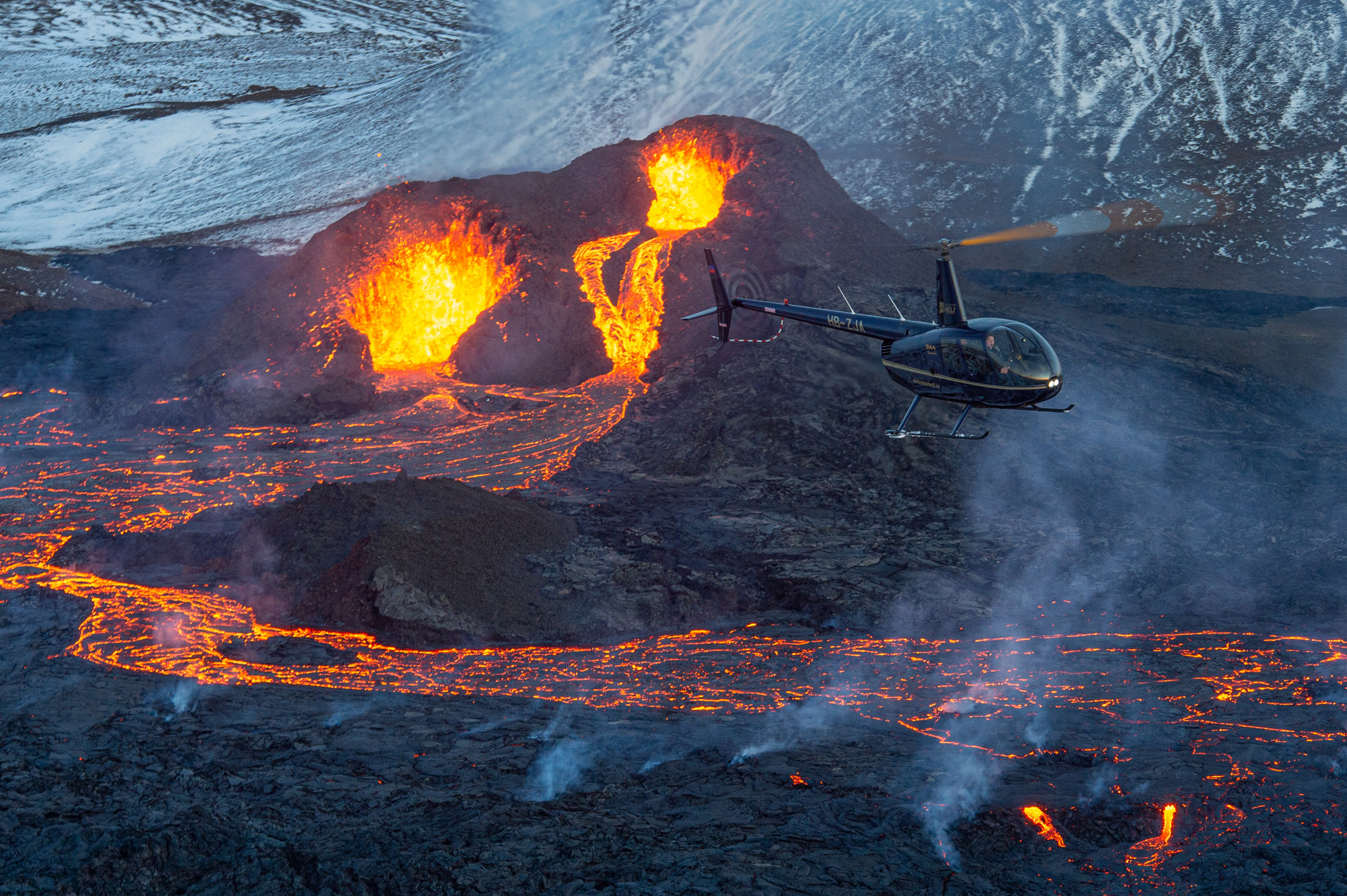 A helicopter flying near an active lava flow during a past eruption on Iceland’s Reykjanes Peninsula.